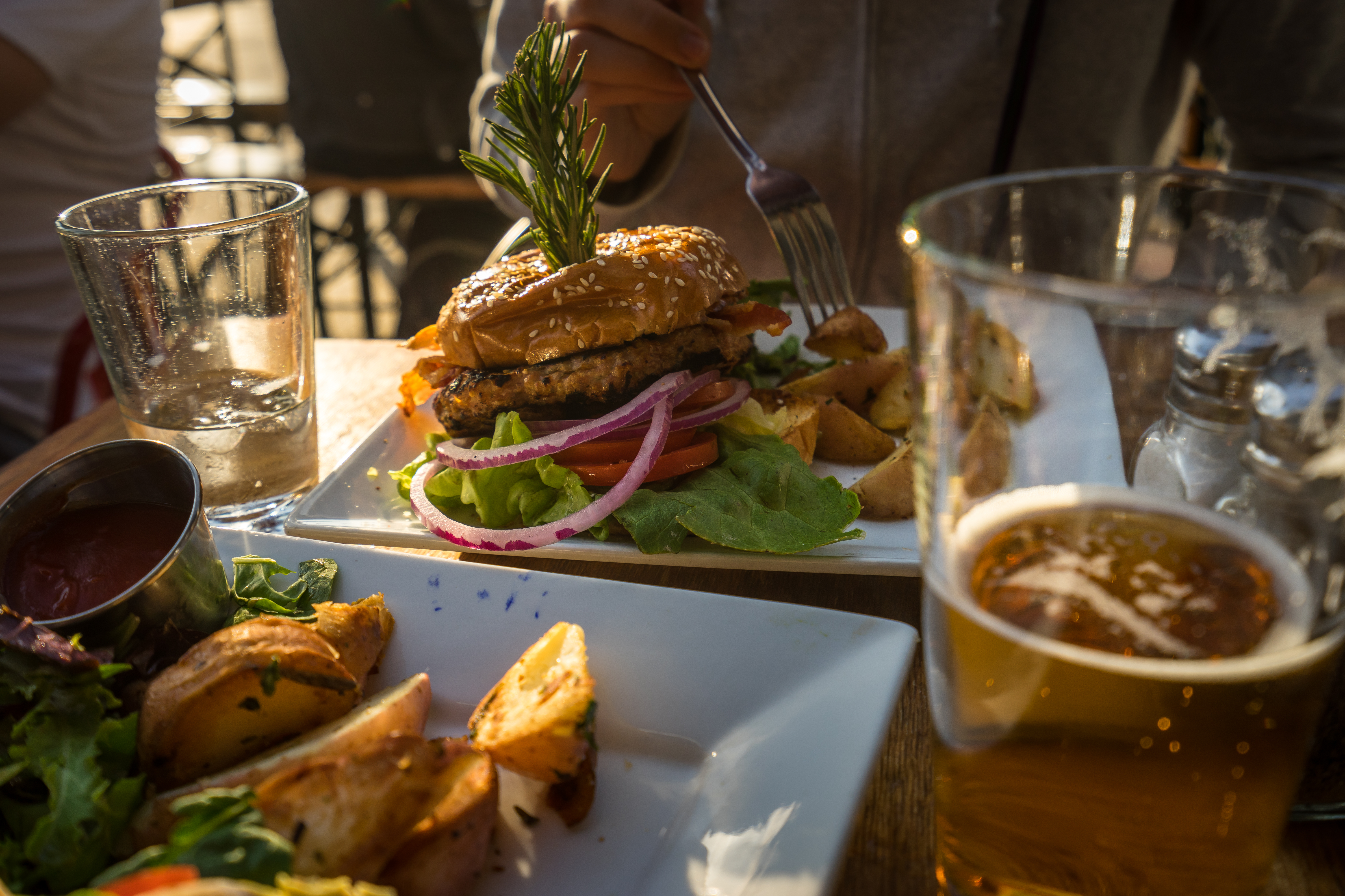 Hamburger and beer. Eating outside on a summer evening in Los Angeles.