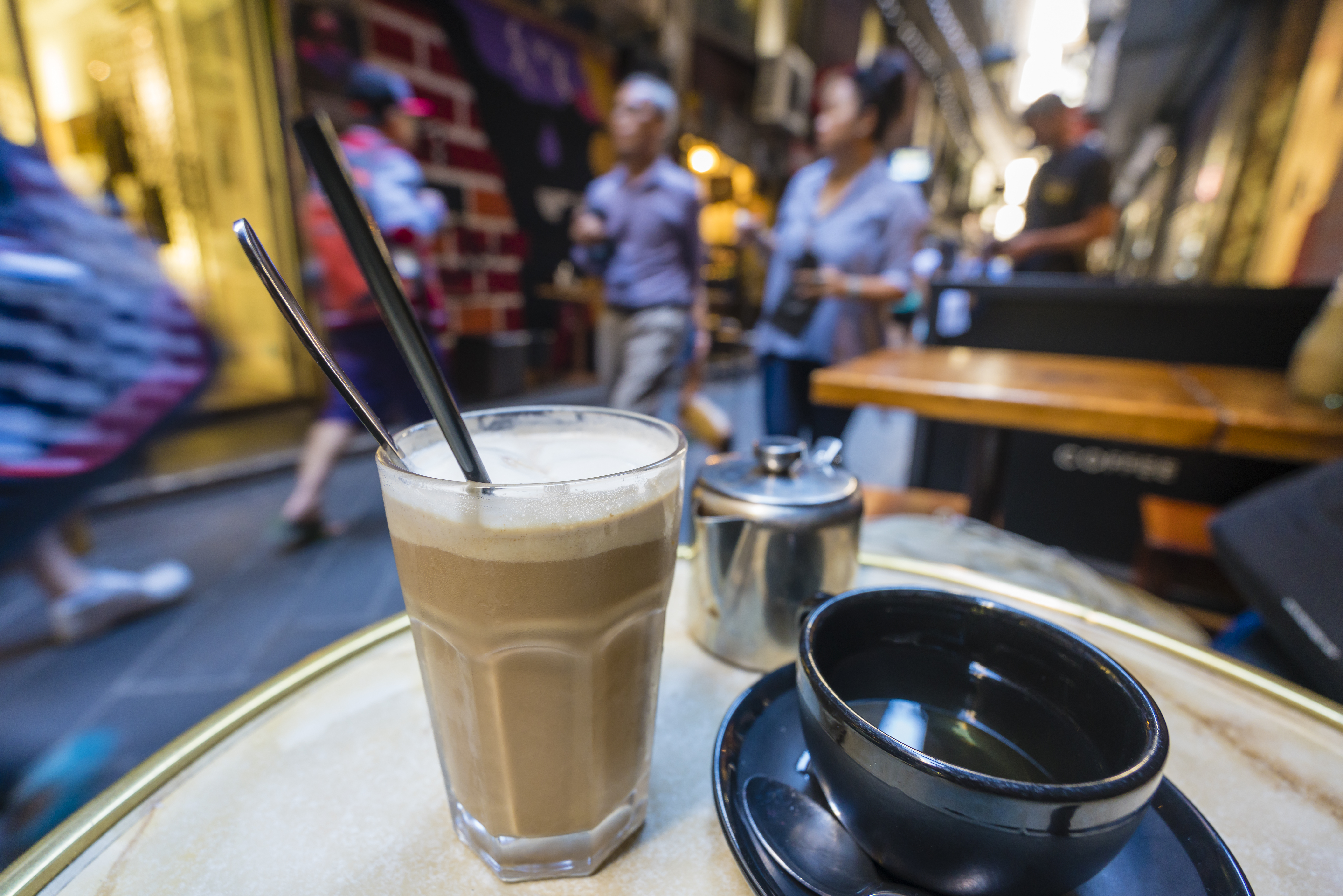 Enjoying coffee and tea at a cafe in a laneway, shallow depth of view