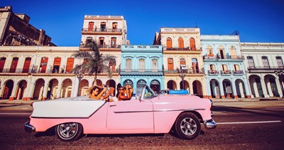 four young women in a pink old car in Havana - Florian Wehde/unsplash