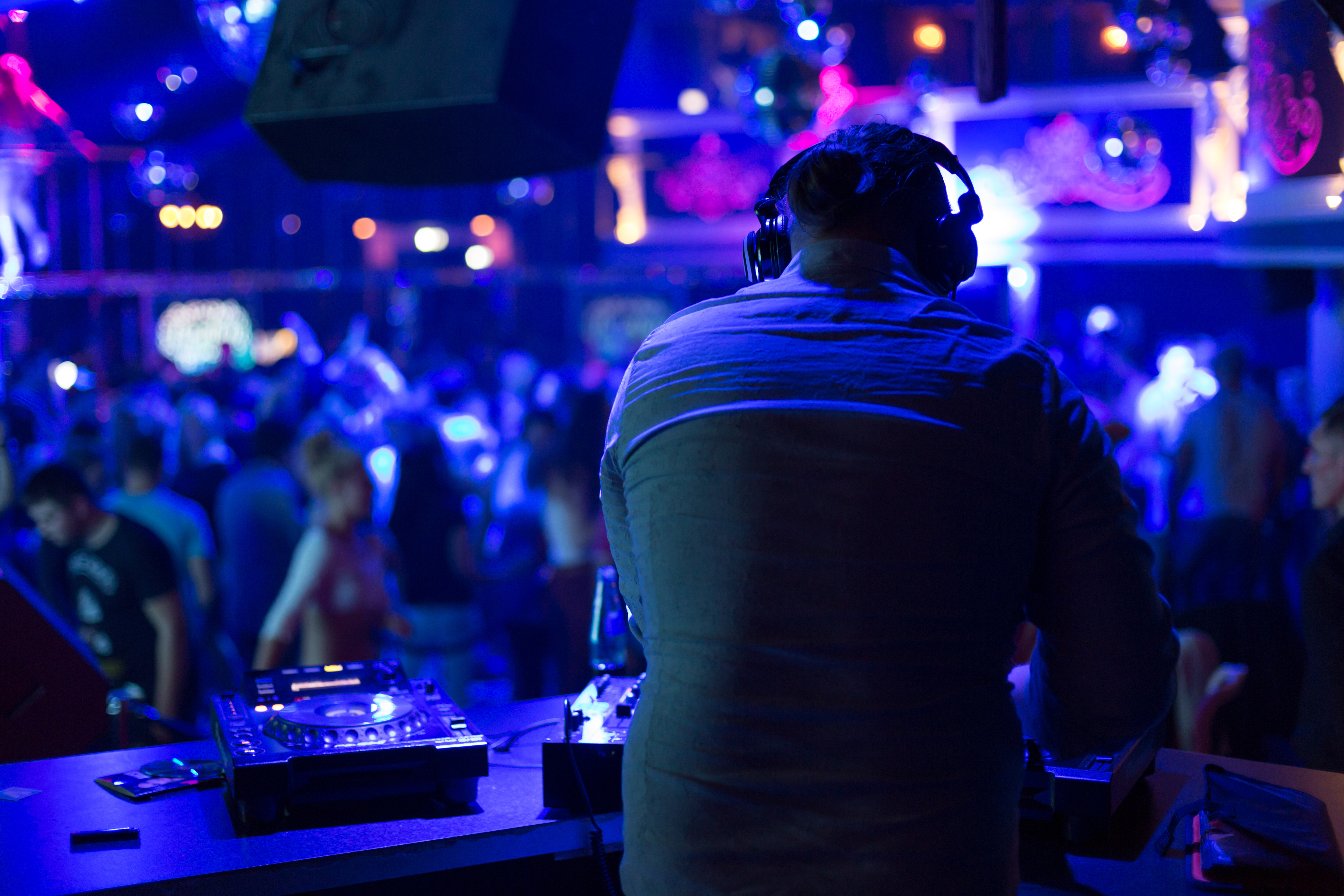 DJ in nightclub playing dance music