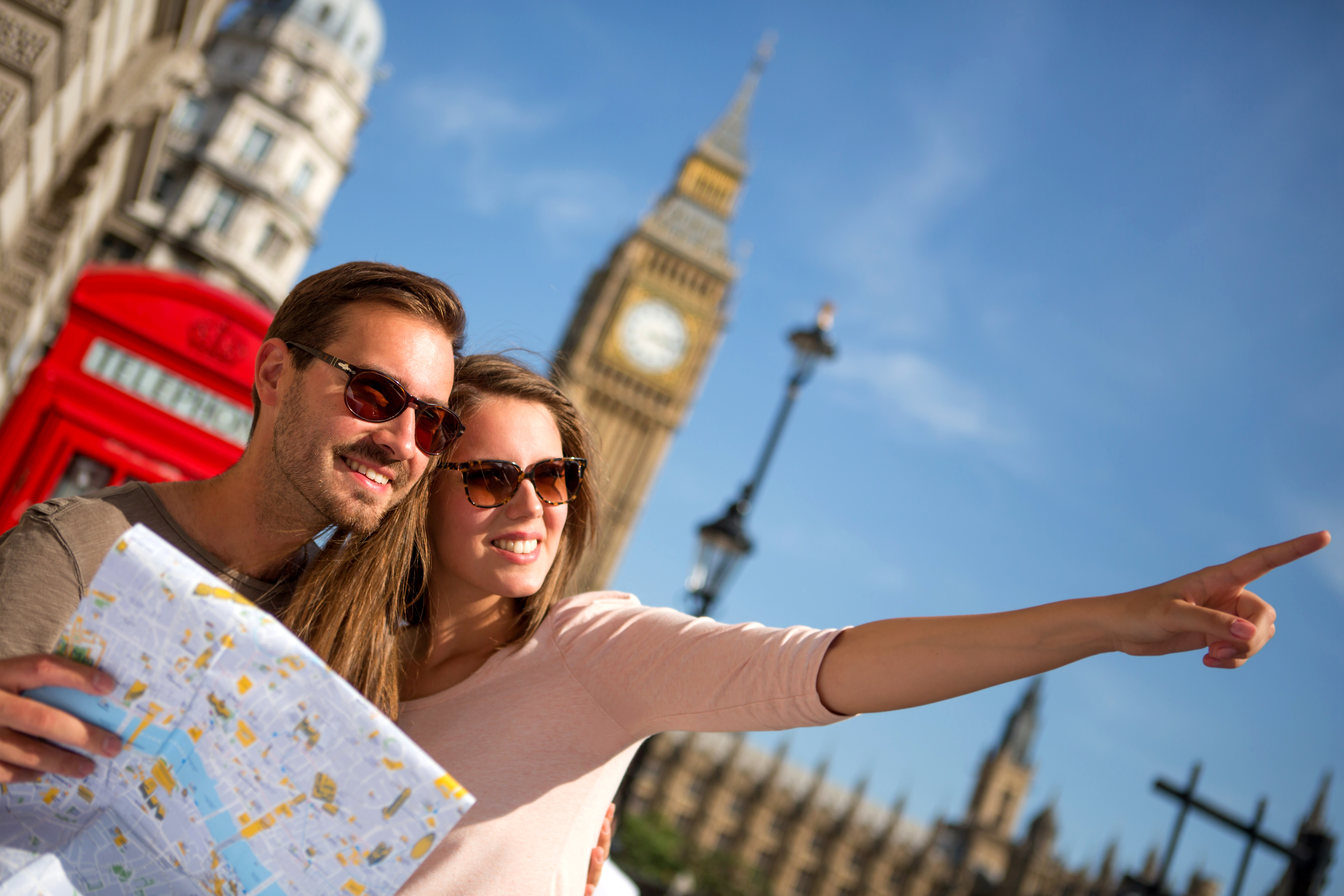 Couple of tourists in London holding a map