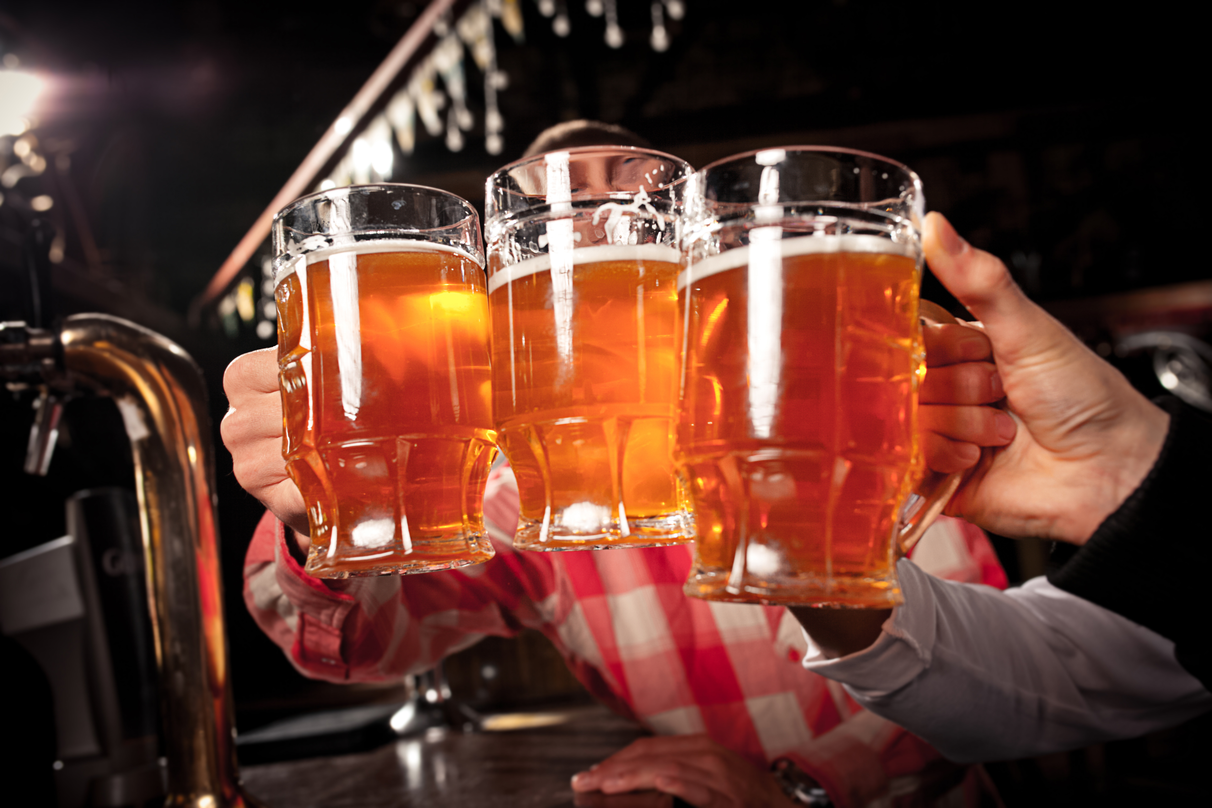 Friends in a pub clinking beers