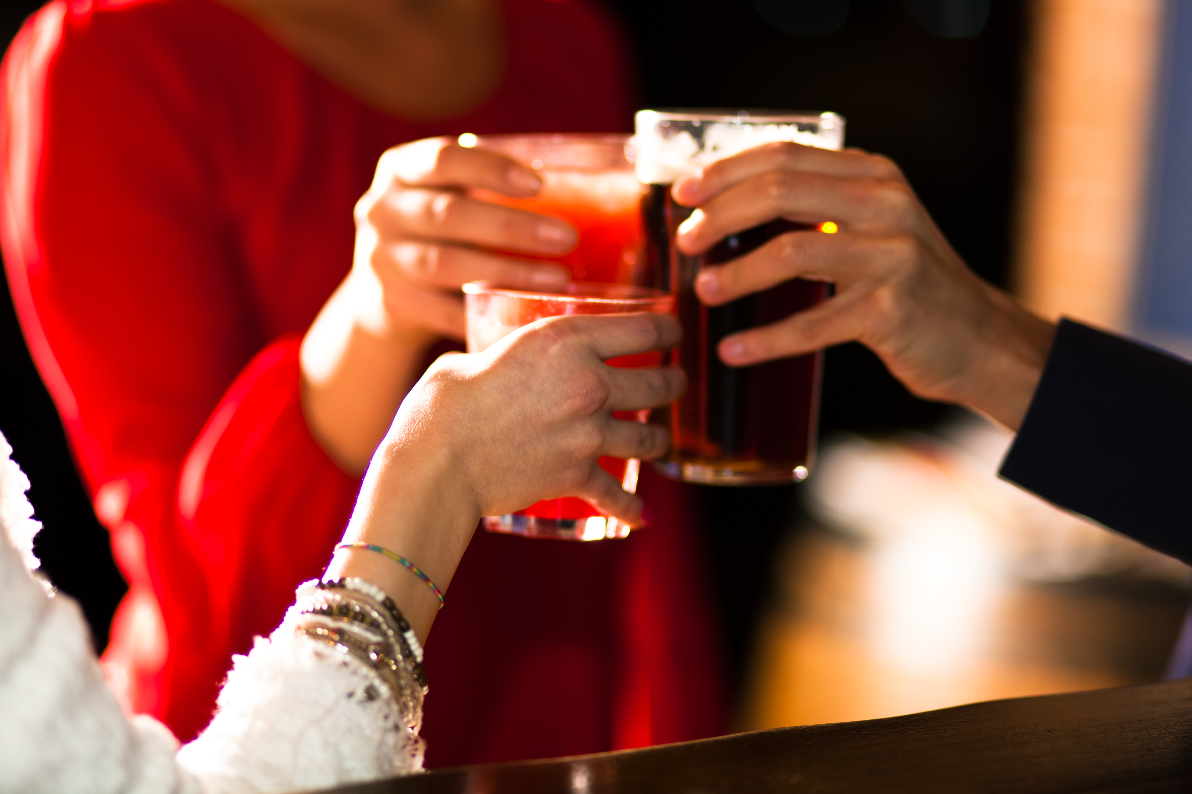 Friends toasting glasses in a pub