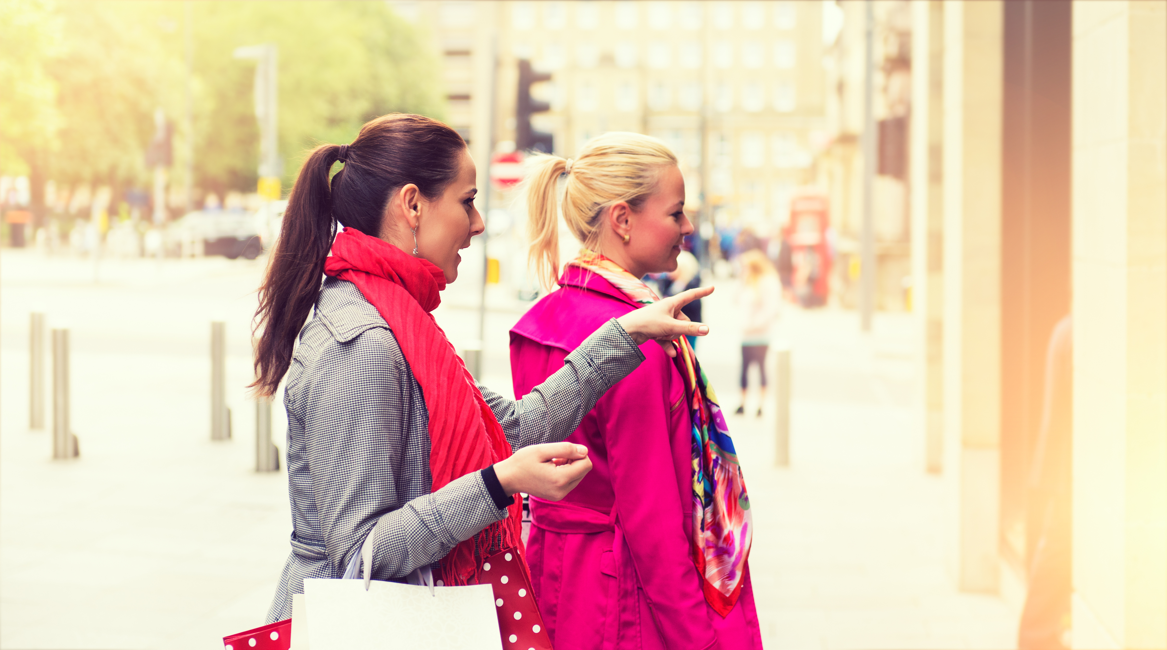 Two attractive young female friends enjoying a day out shopping