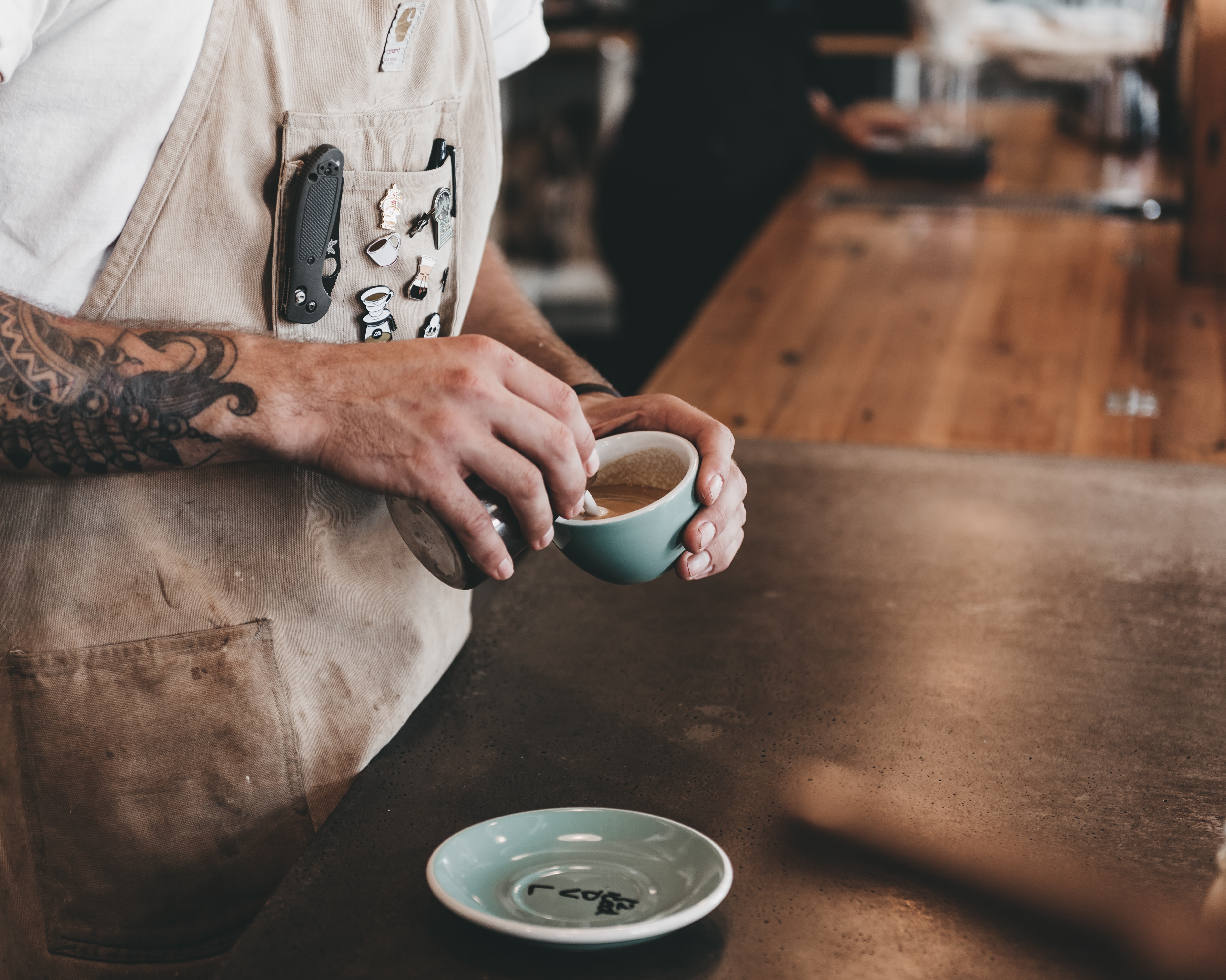 Barista pouring a cup of coffee