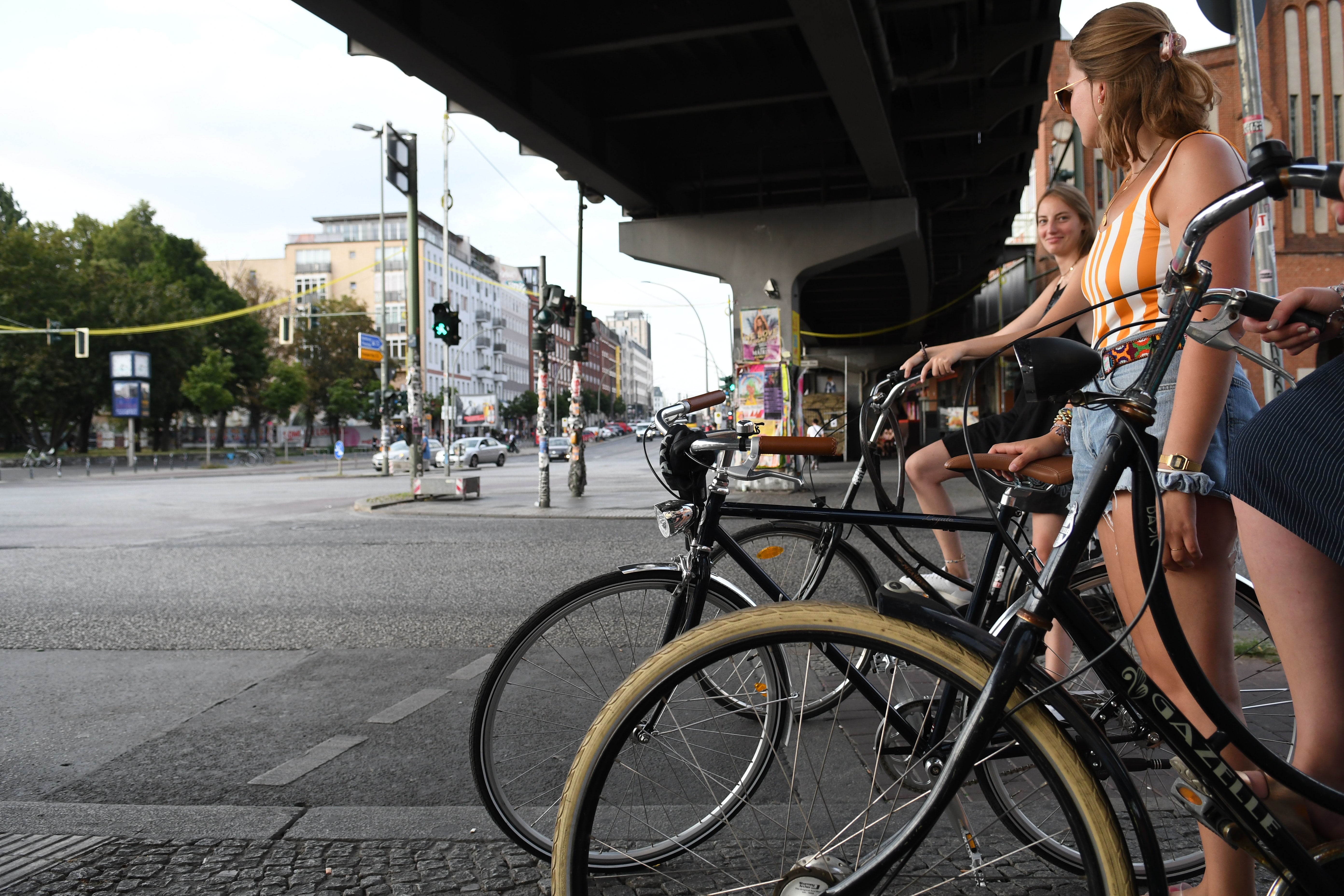 3 women biking around Kreuzberg in the summer, Berlin, Germany