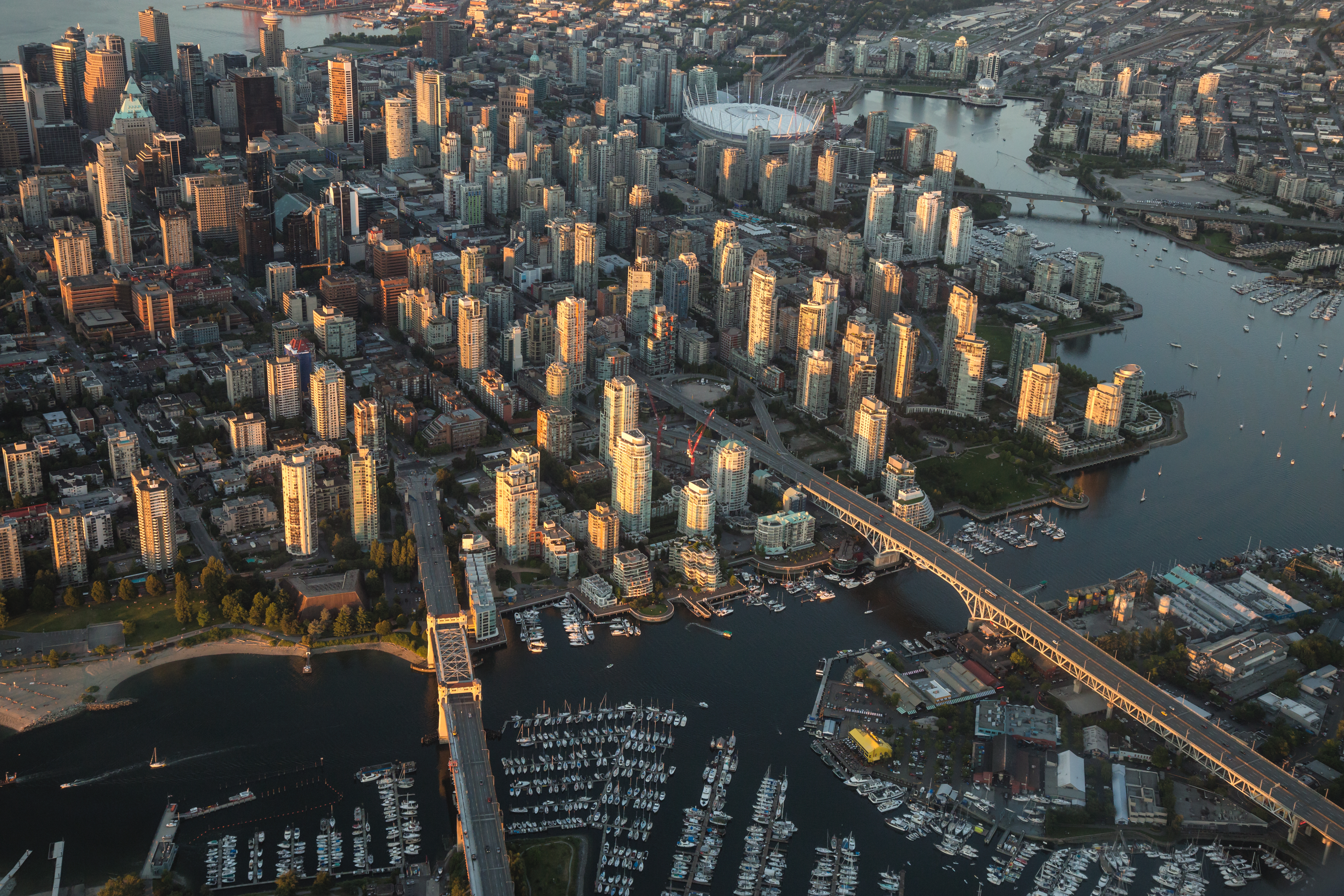 Aerial Photography of False Creek, Cambie Bridge and Granville Bridge in Downtown Vancouver, BC, Canada, on a Hazy sunny sunset.