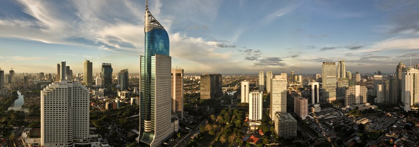 Panoramic cityscape of Indonesia capital city Jakarta at sunset. A r