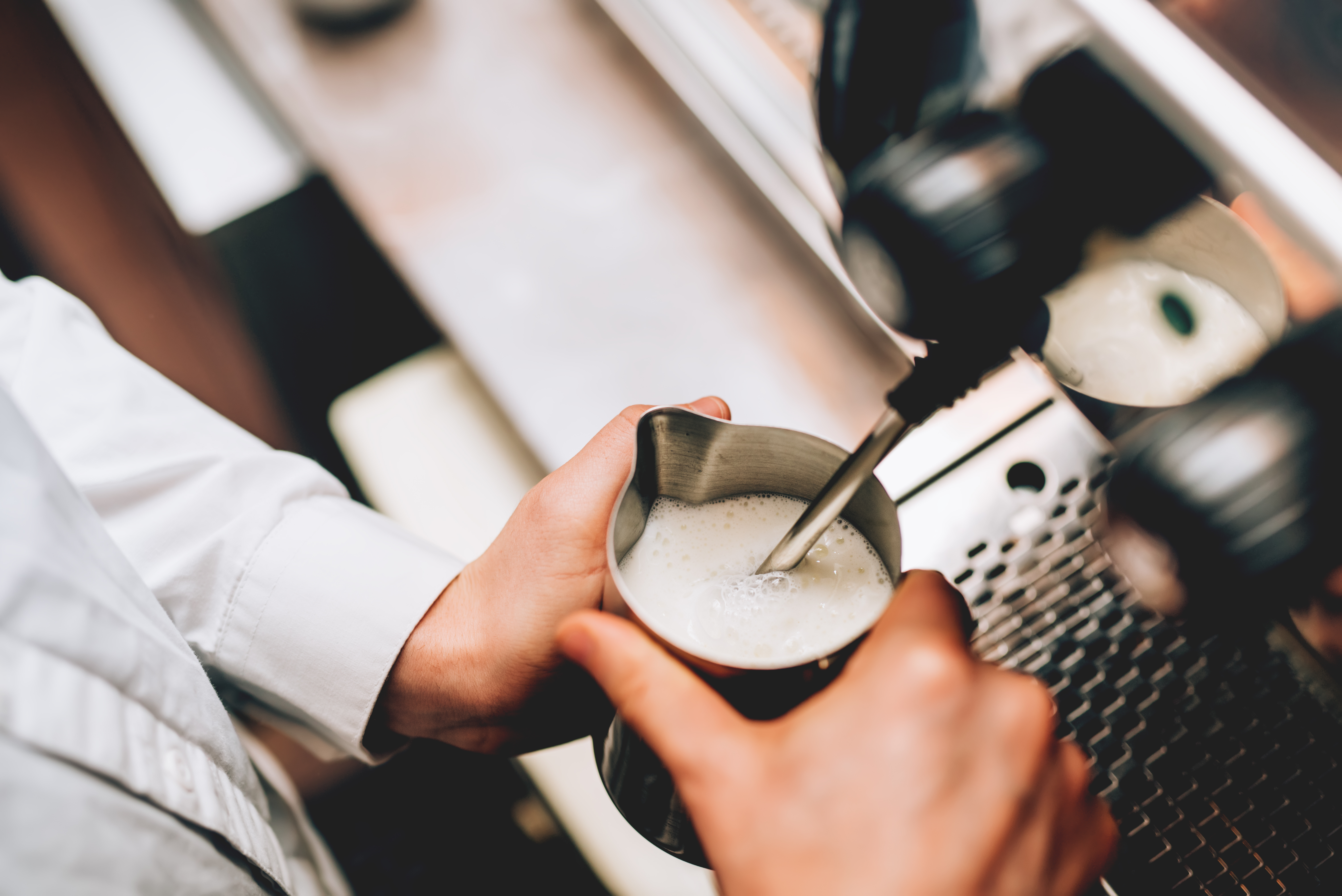 foaming milk at cafe