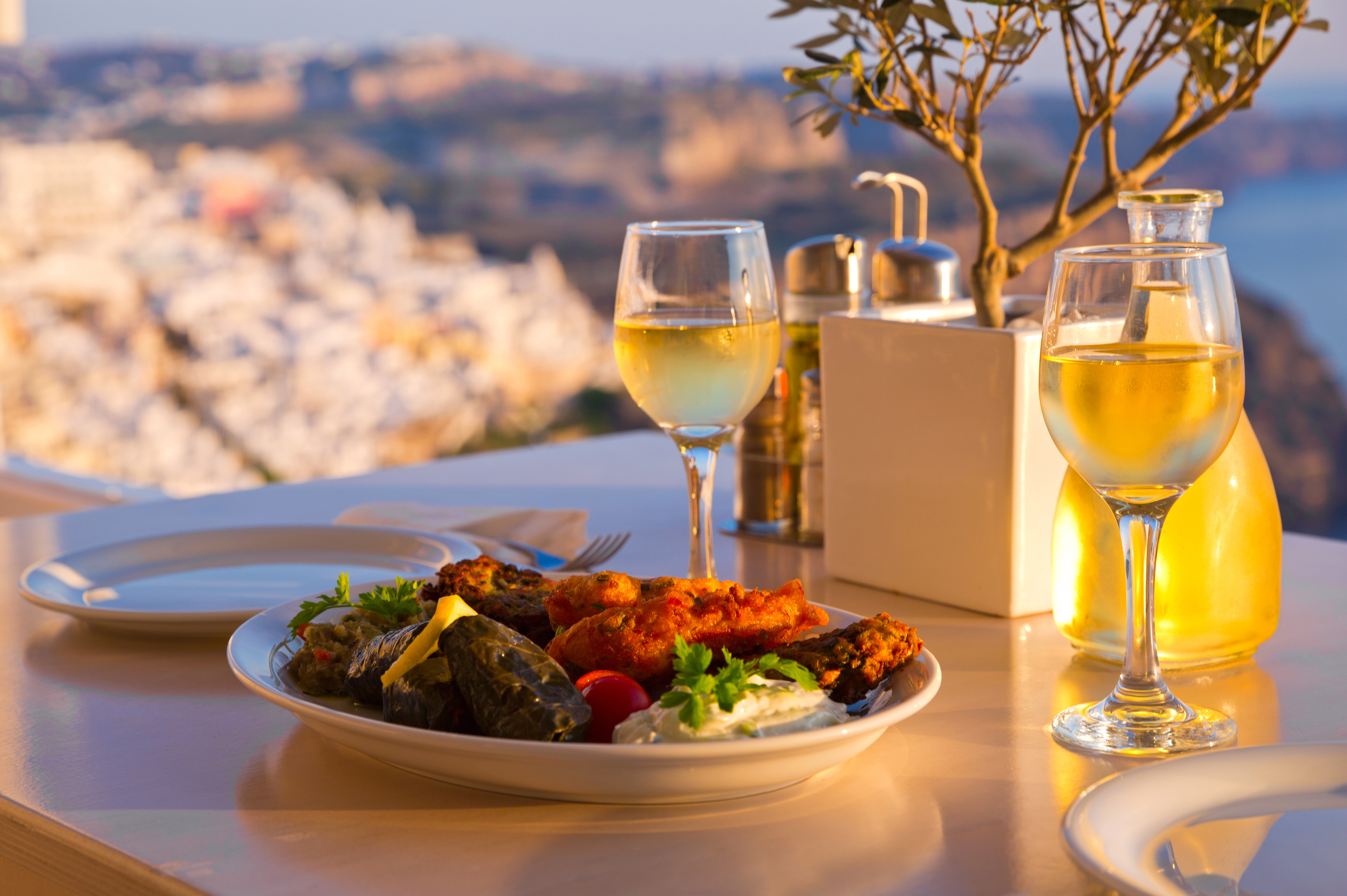 Dinner for two at sunset.Greece, Santorini, restaurant on the beach, above the volcano