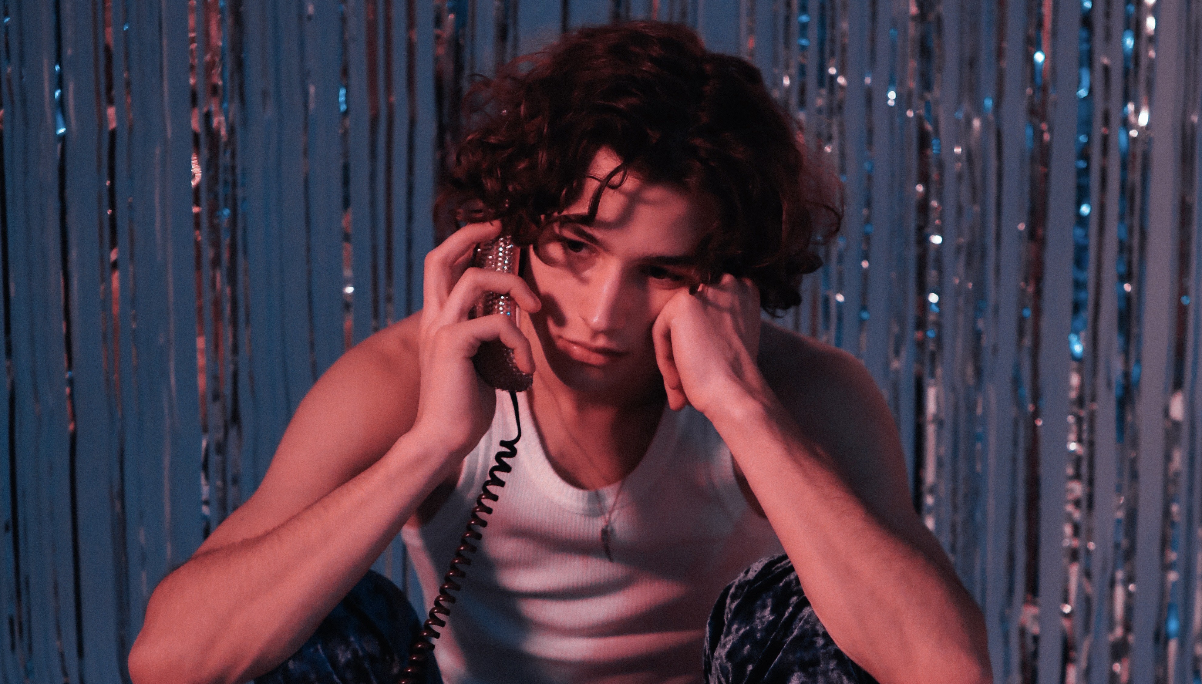 Man Sitting on the Ground Talking on the Telephone