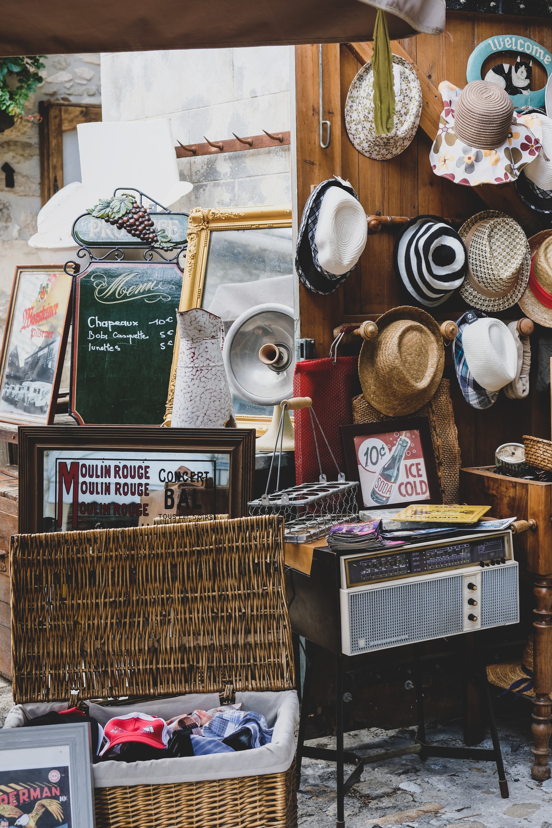 brown basket with vintage hats and items