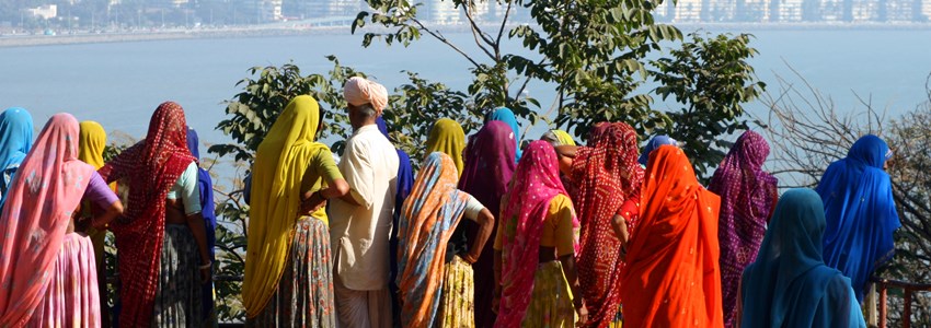 A group of indian women looking at the skyline of mumbai