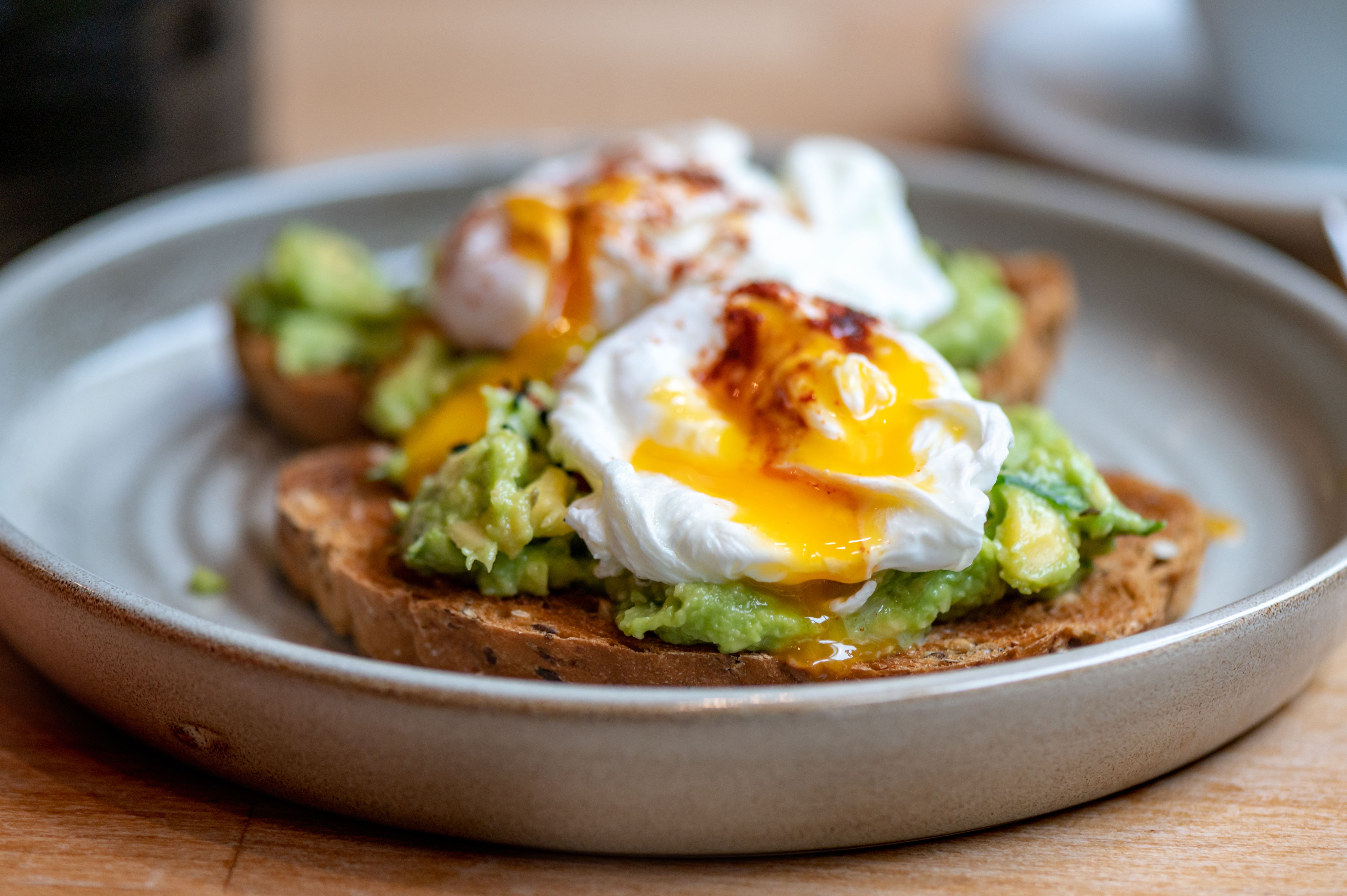 Healthy Breakfast with Wholemeal Bread Toast and Poached Egg with mashed Avocado