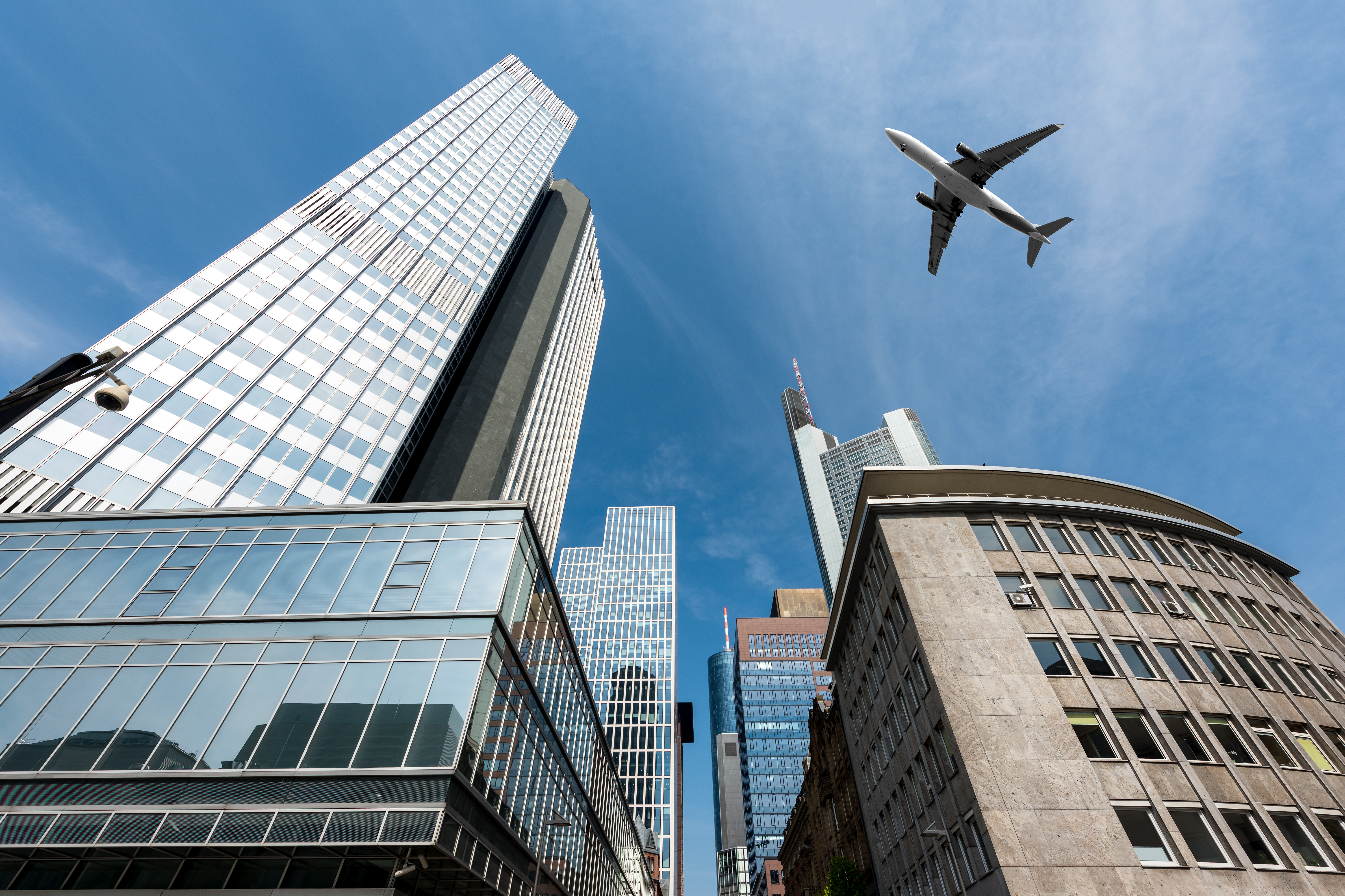 Frankfurt skyscrapers buildings and a plane flying overhead in morning at Frankfurt, Germany.