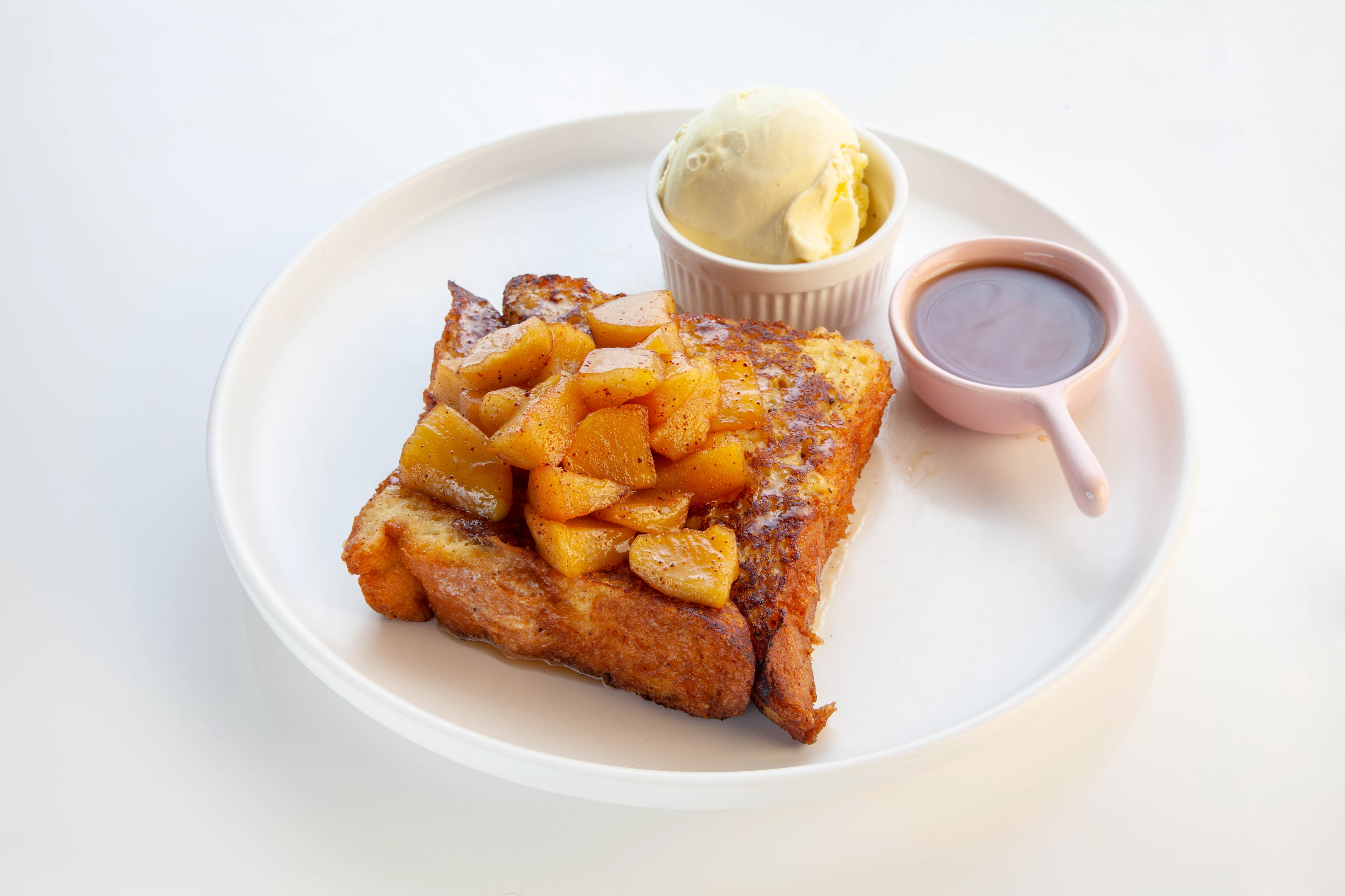 Apple pie french toast with ice cream and maple syrup.