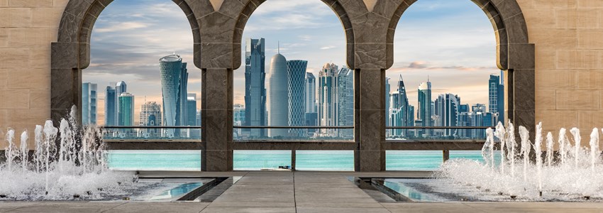 The skyline of Doha, Qatar, seen through arches