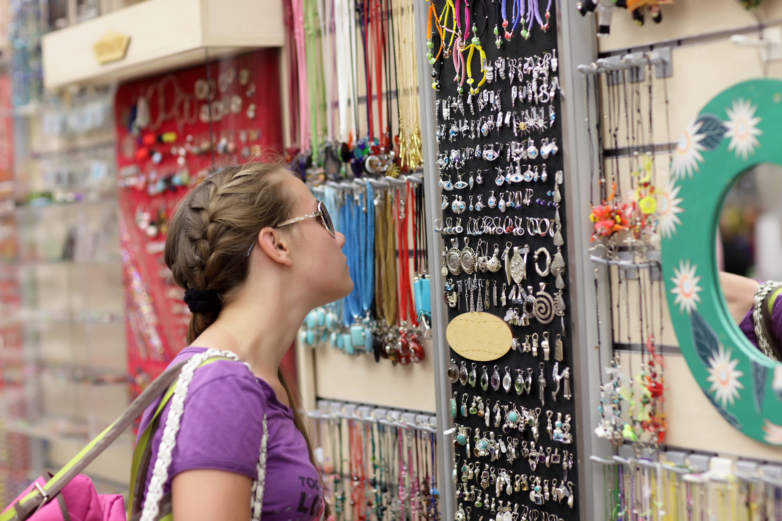 Girl choosing souvenir at a Greek market, Athens