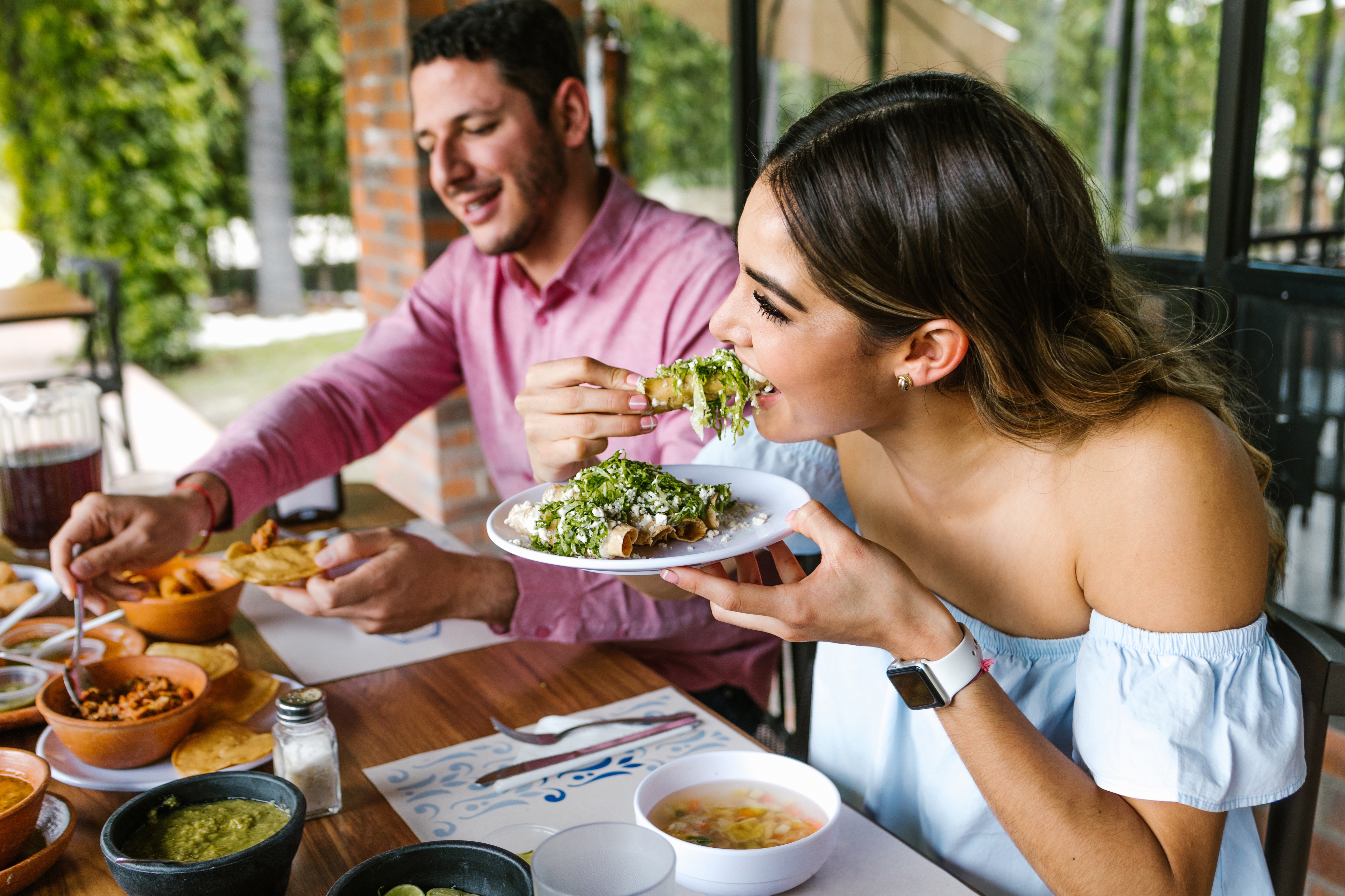 young woman eating tacos at a restaurant in Mexico