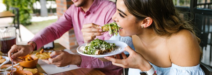 young woman eating tacos at a restaurant in Mexico
