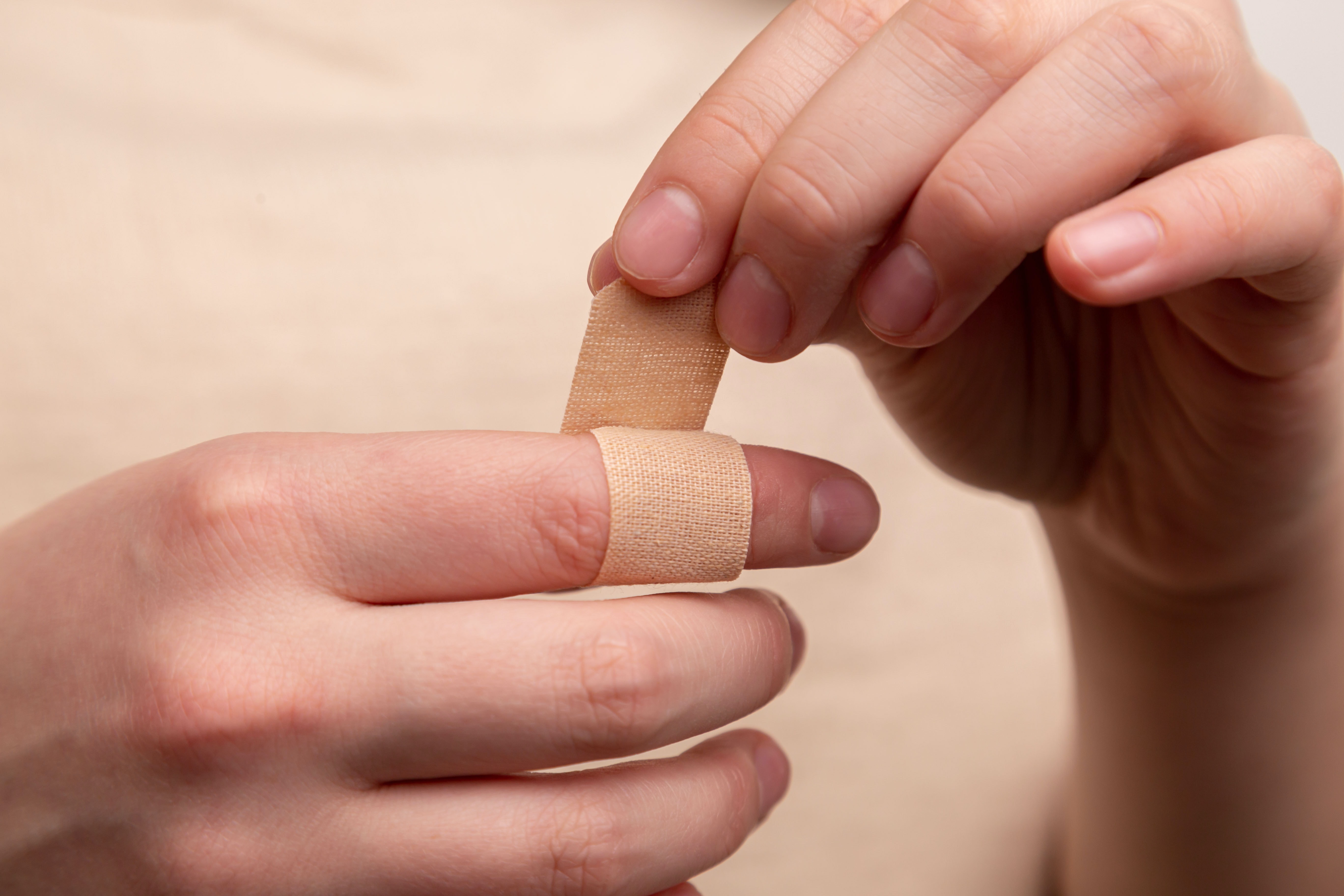 applying a plaster to finger