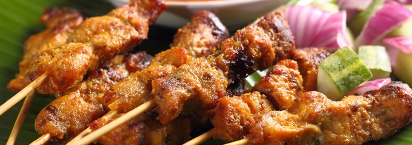 Malaysian chicken satay with delicious peanut sauce, one of famous local dishes.