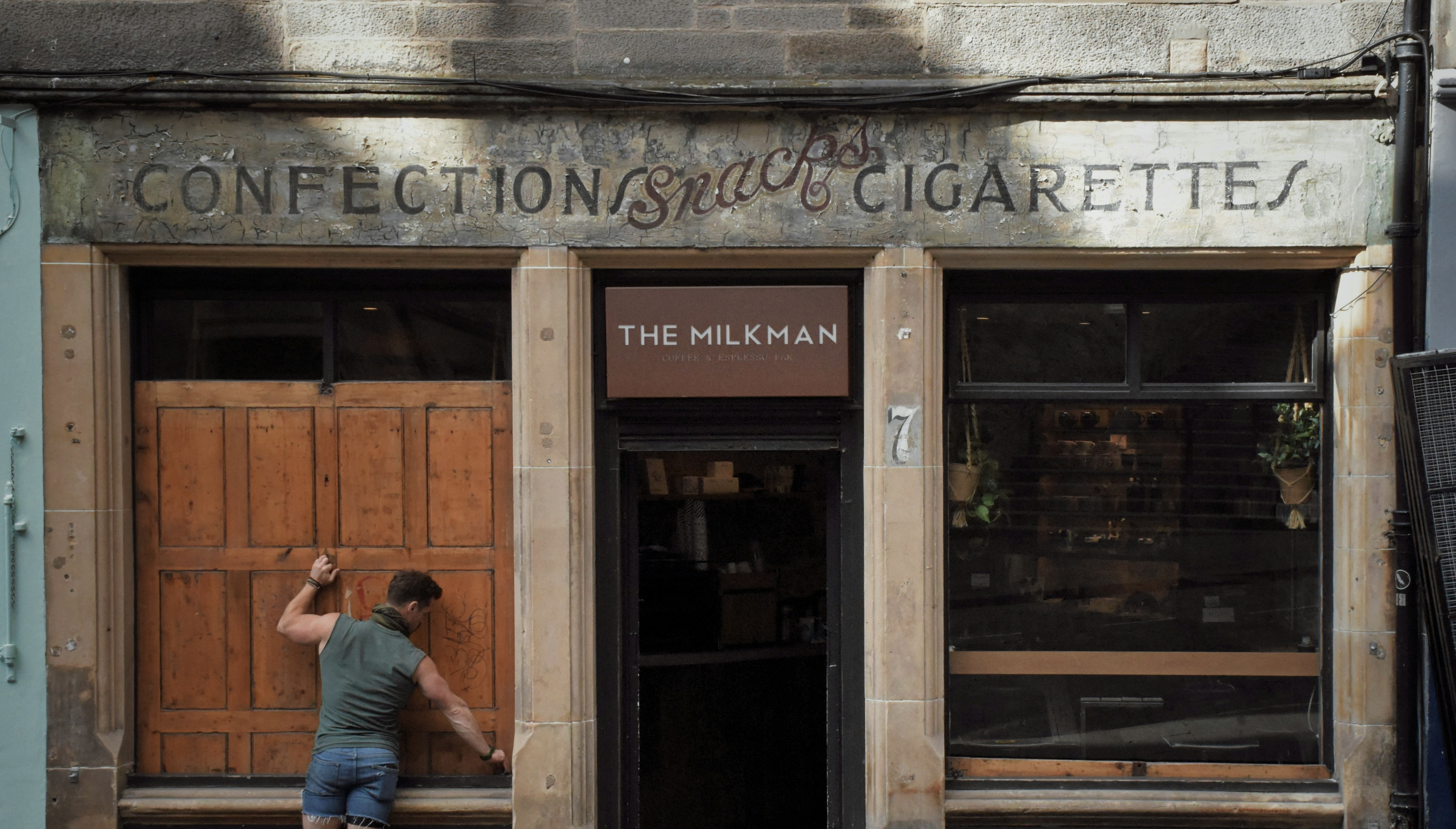 man opening The Milkman cafe