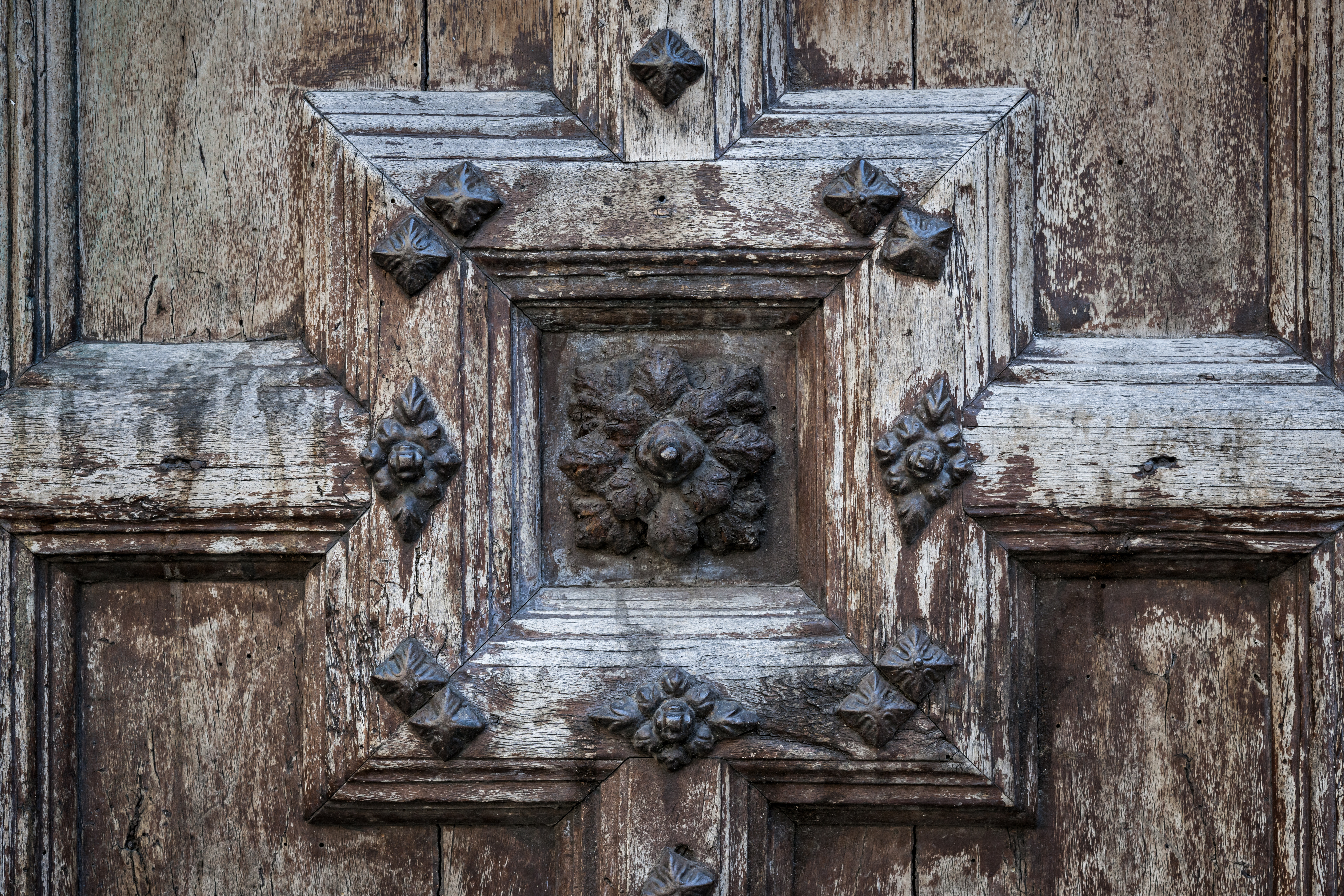 Ornate old wooden door detail of the Church of the Jacobins in Toulouse, France.