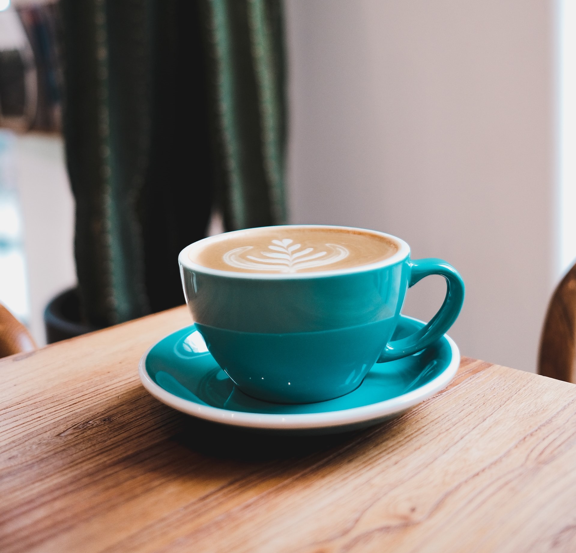 blue cup with cappuccino in café