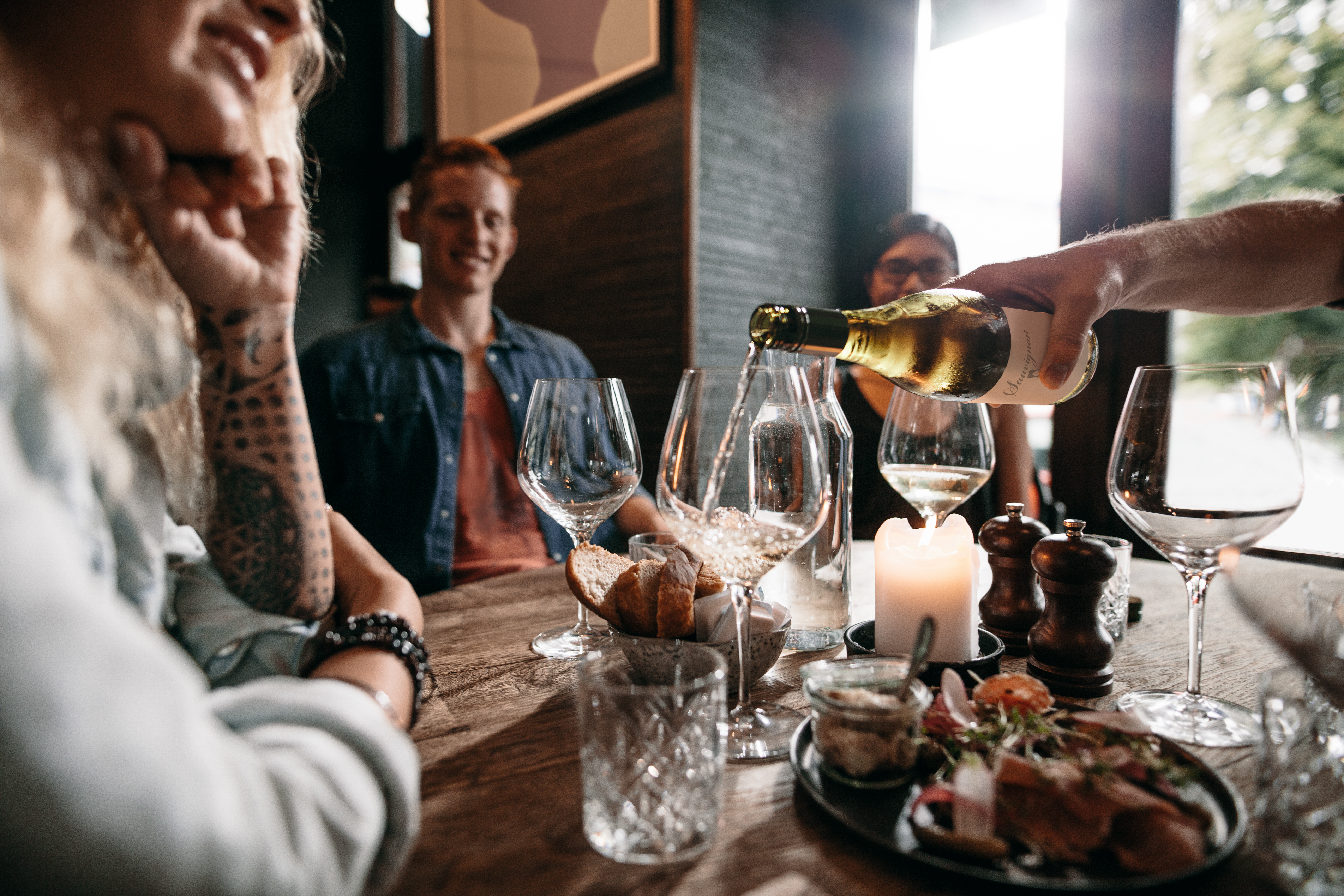 Group of friends drinking wine at restaurant