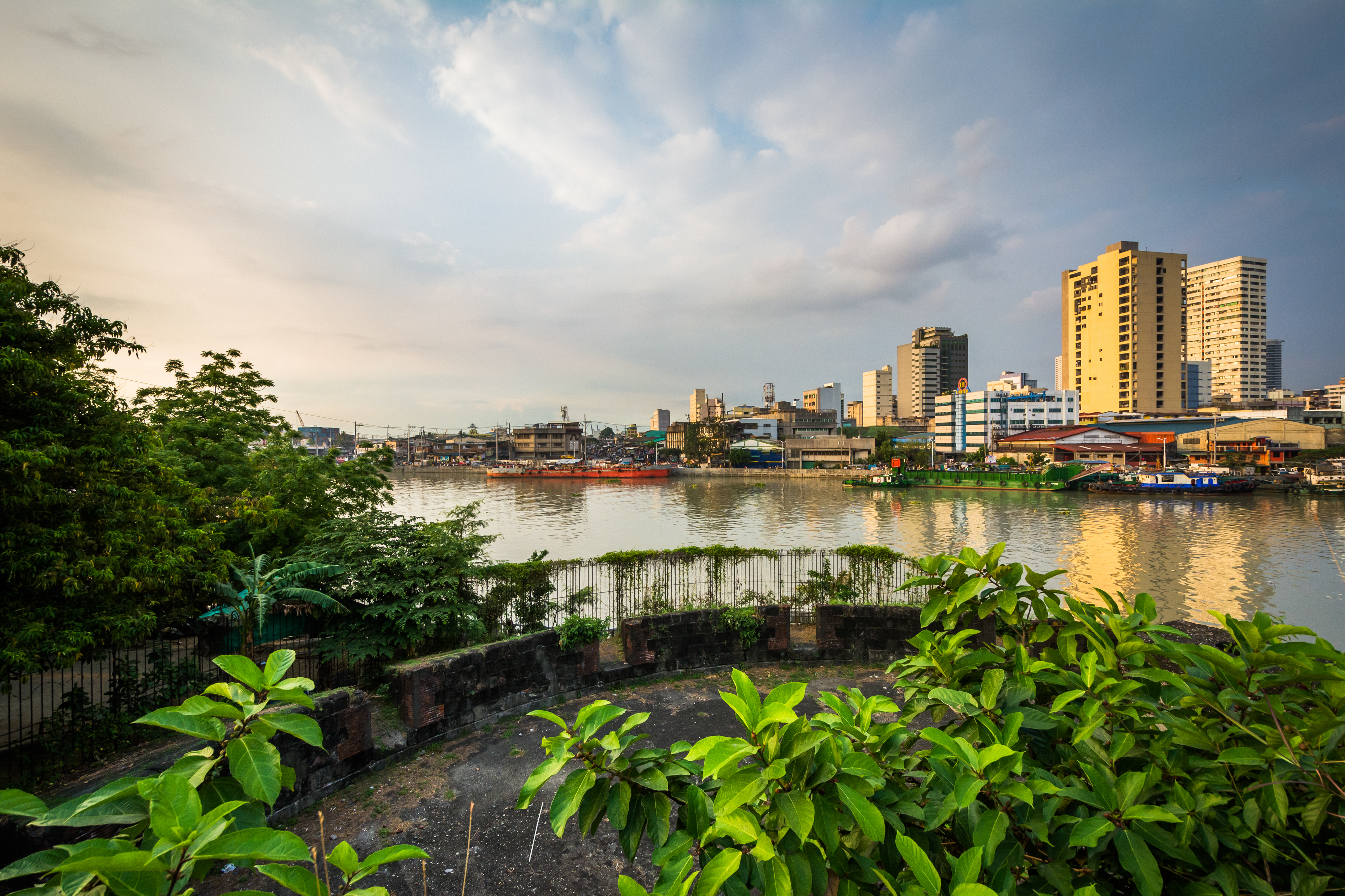 Ruins at Fort Santiago and buildings along the Pasay River, in Intramuros, Manila, The Philippines.