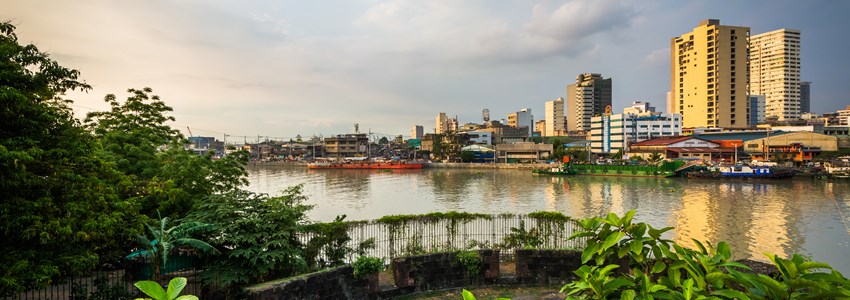 Ruins at Fort Santiago and buildings along the Pasay River, in Intramuros, Manila, The Philippines.