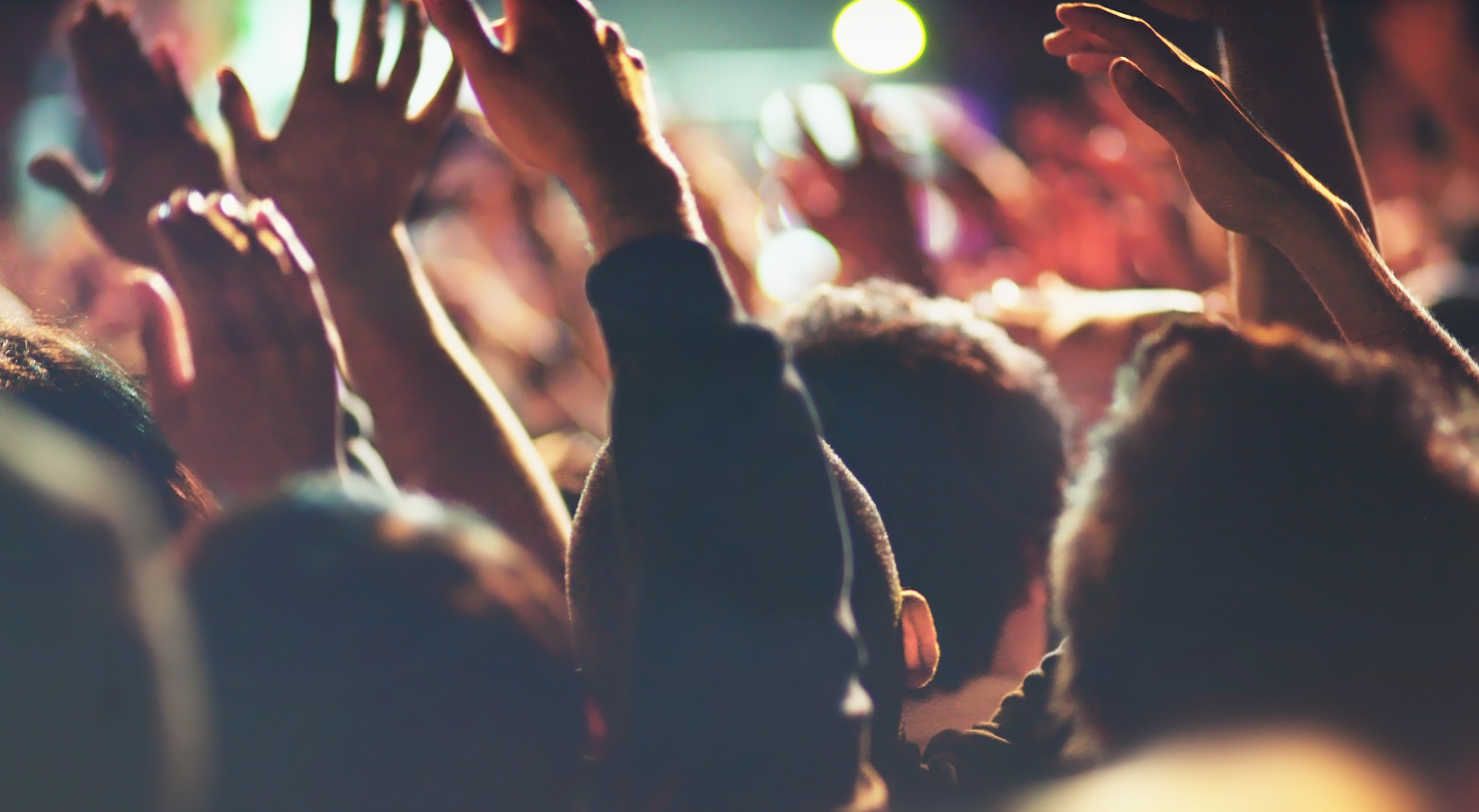 Concert People with Hands Up Excited Attendees Listening to Live Music