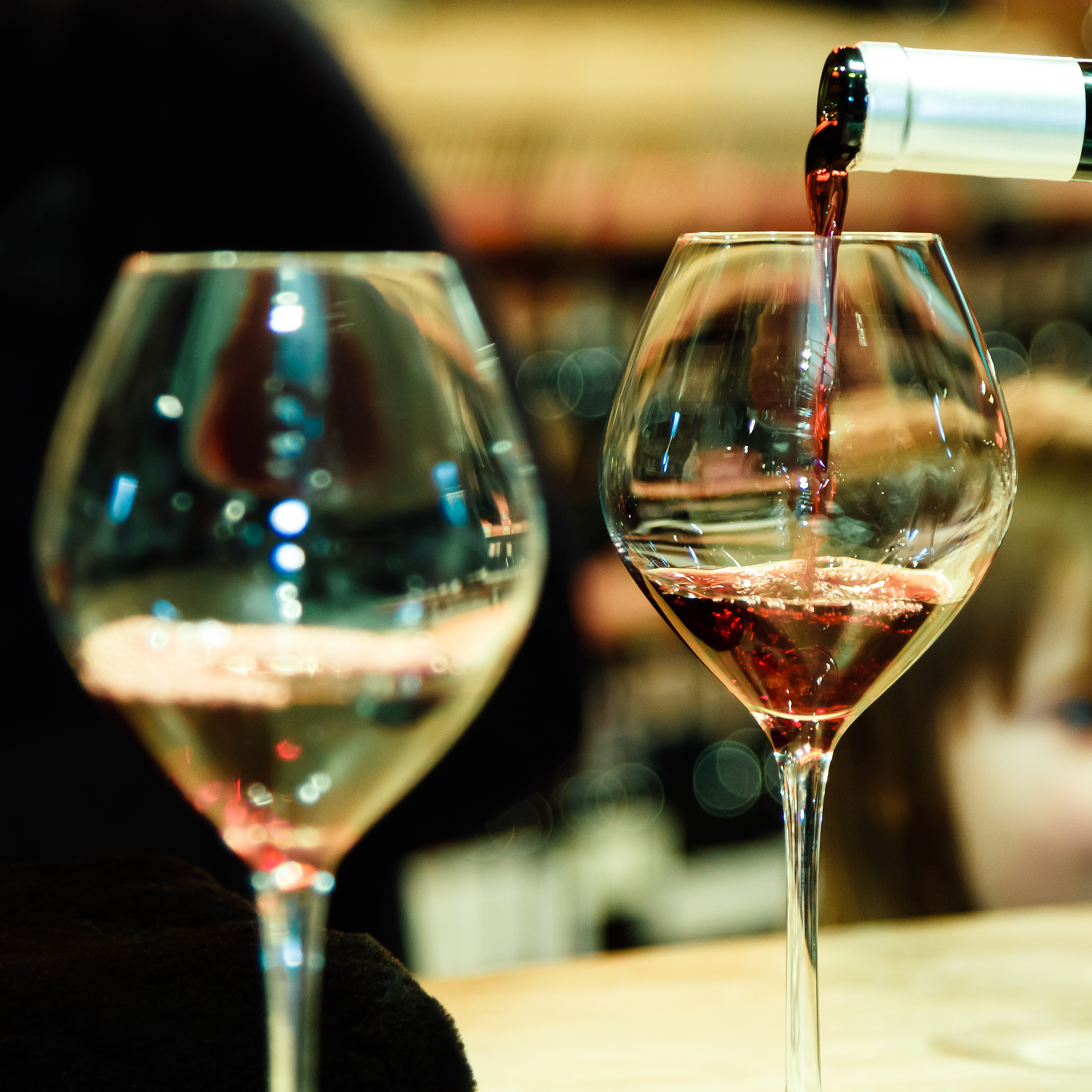 Red wine pouring into a wine glass.