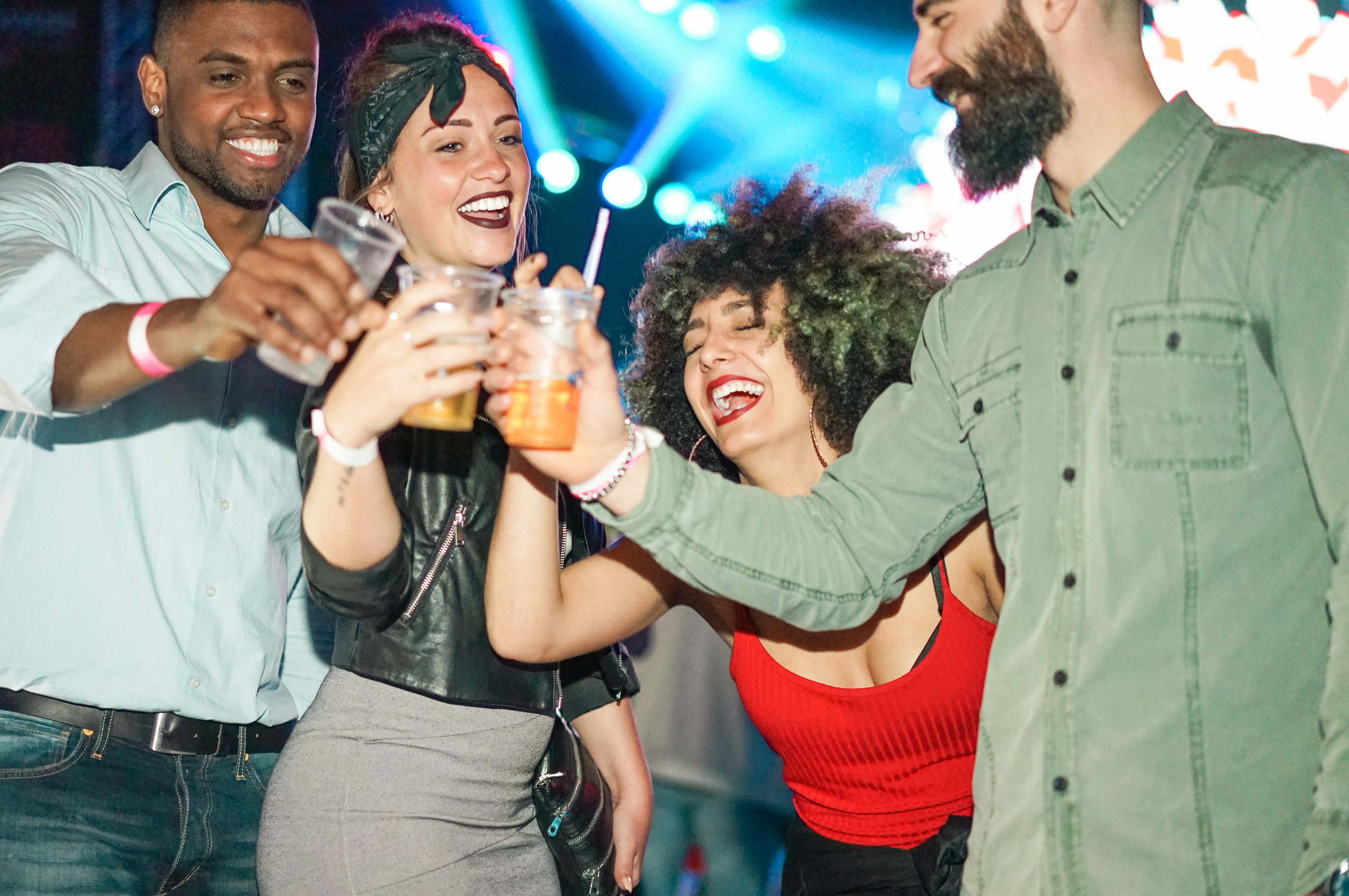 Happy friends having party in club at night