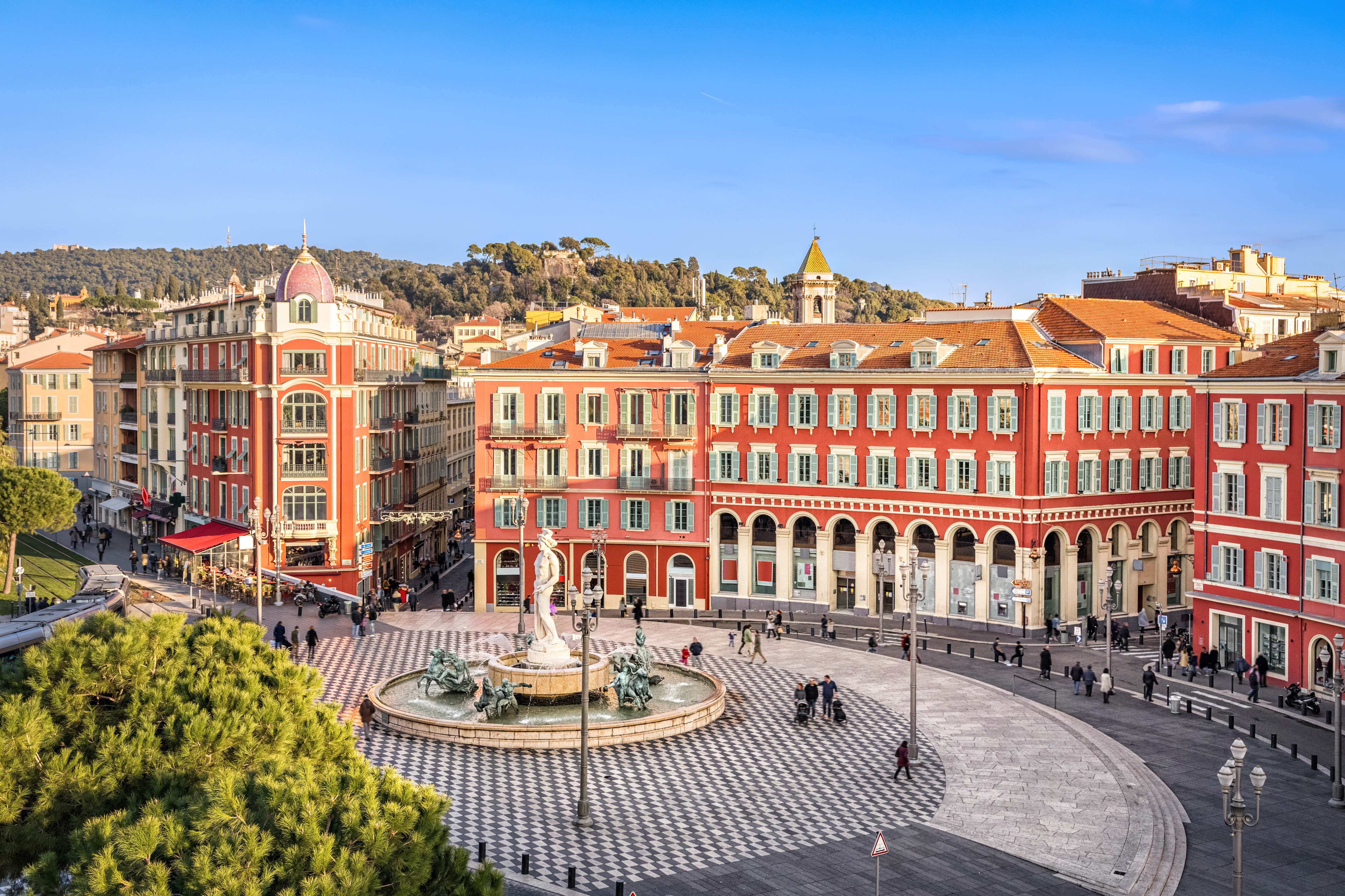 Aerial view of Place Massena square with red buildings and fountain in Nice
