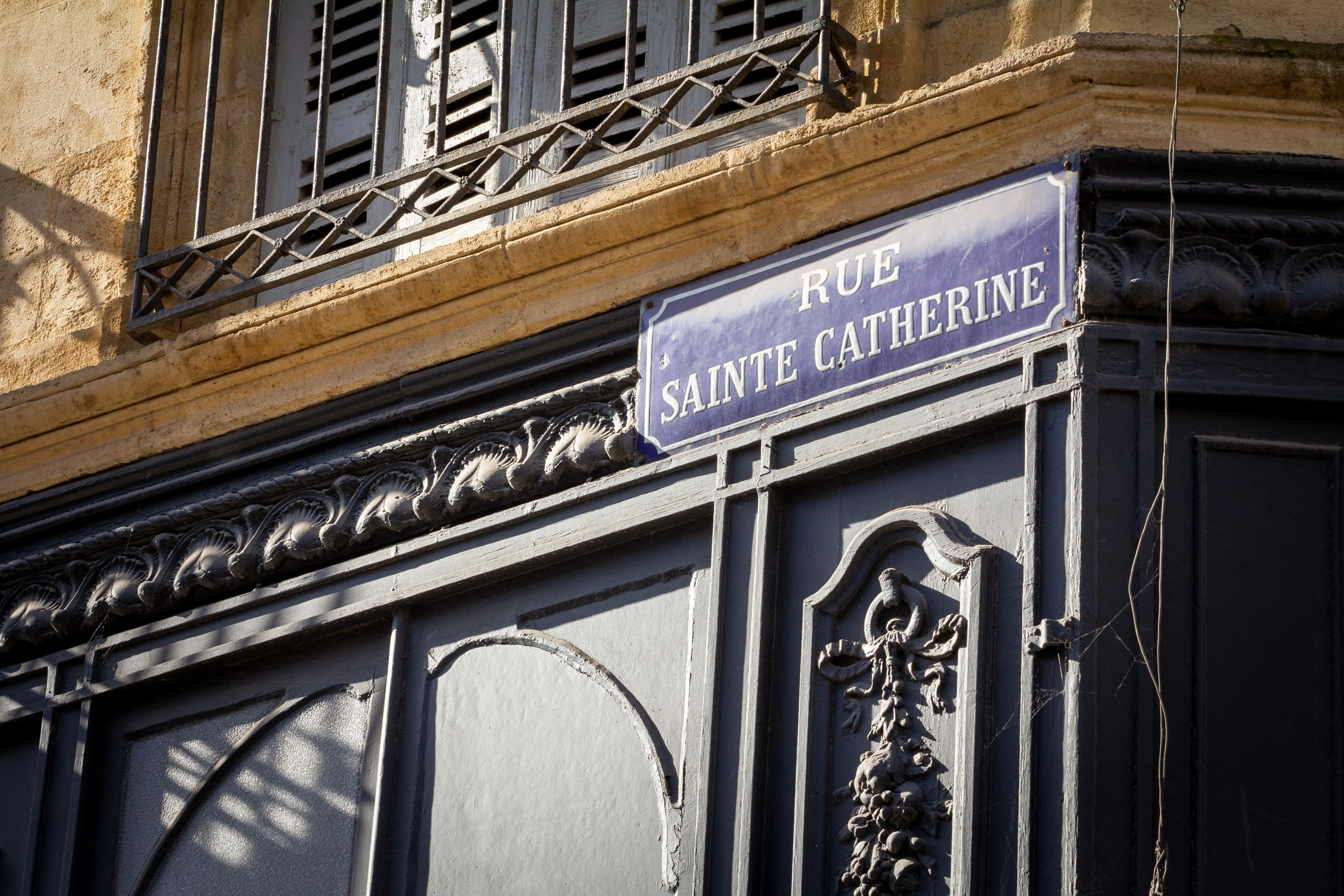 Street sign of Rue Sainte Catherine Street in Bordeaux, France, a vintage sign, called plaque de rue. Rue Sainte Catherine is the main shopping avenue and pedestrian axis of Bordeaux, France.