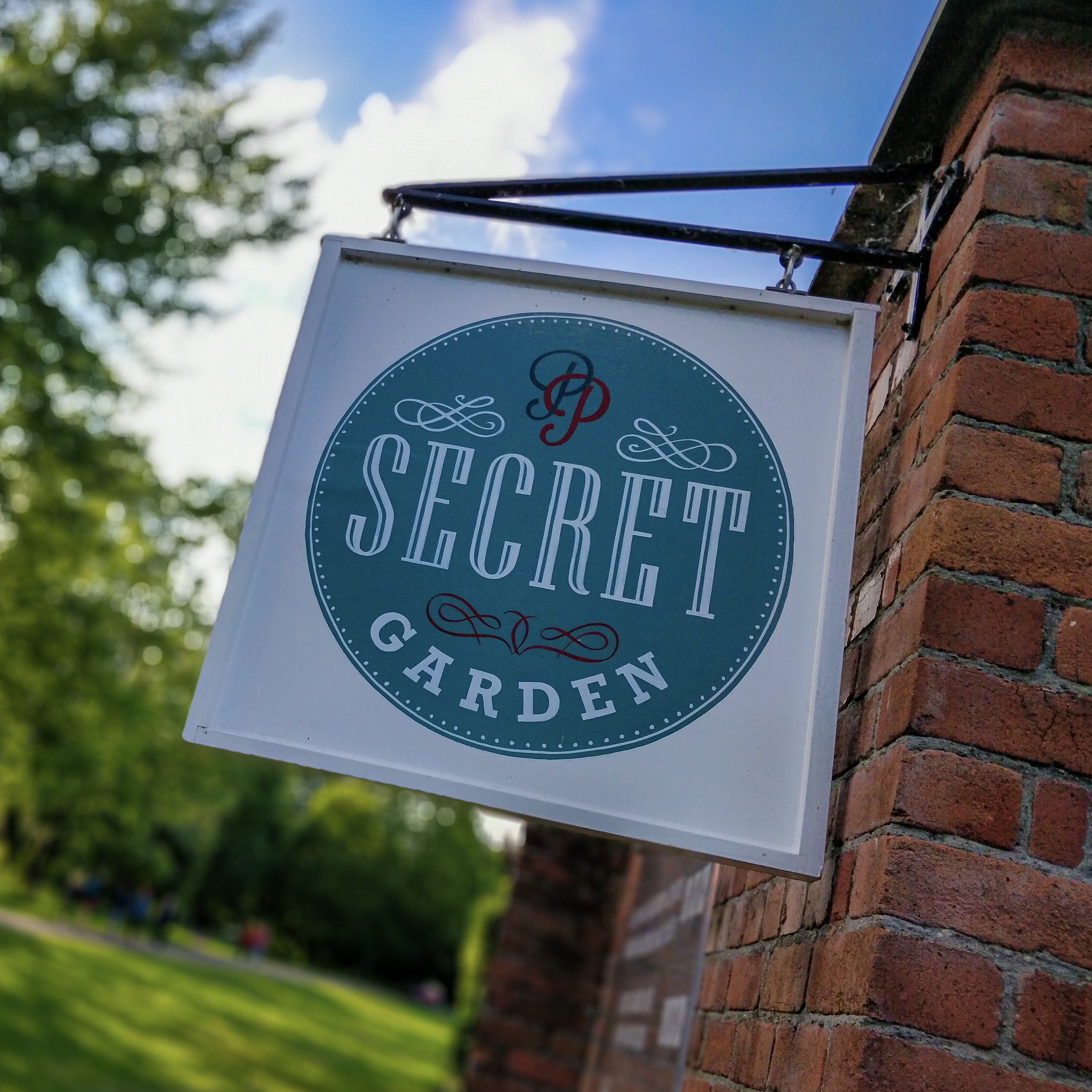 A sign for the Secret Garden cafe in Bute Park