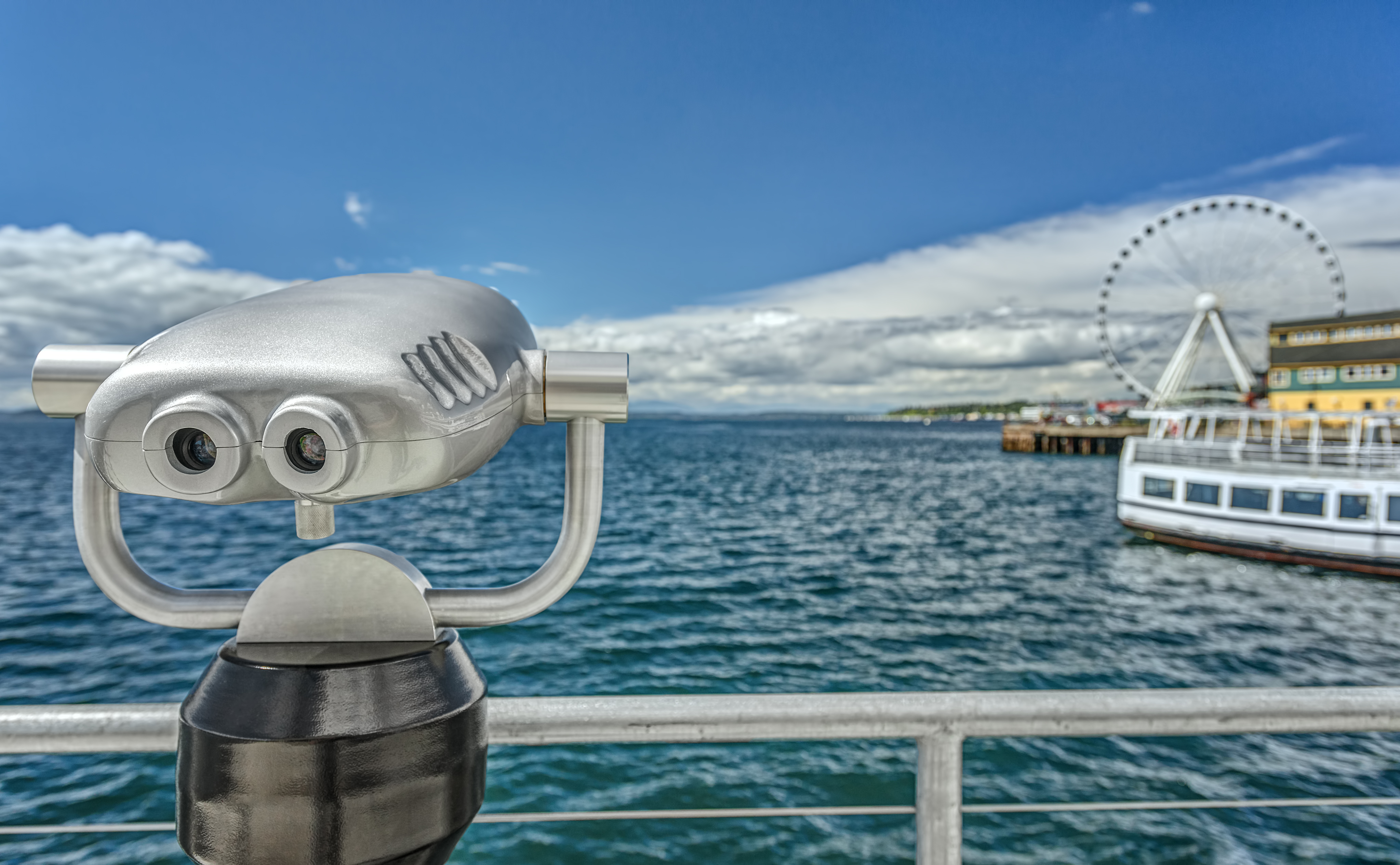 Coin Operated Binoculars Look out towards the Seattle Great Wheel on a Sunny Day