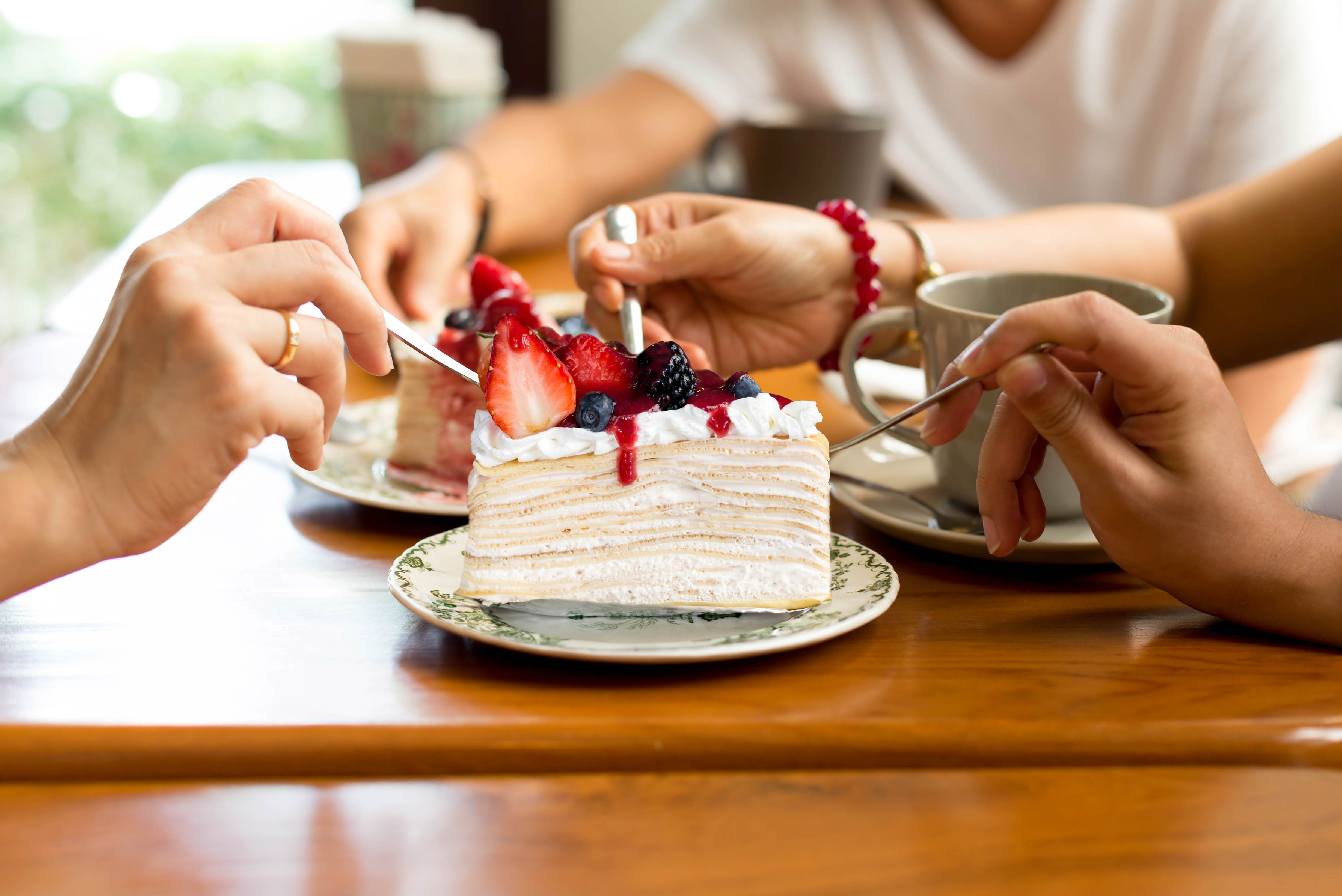Happy family enjoy eating cake in the restaurant. indoor