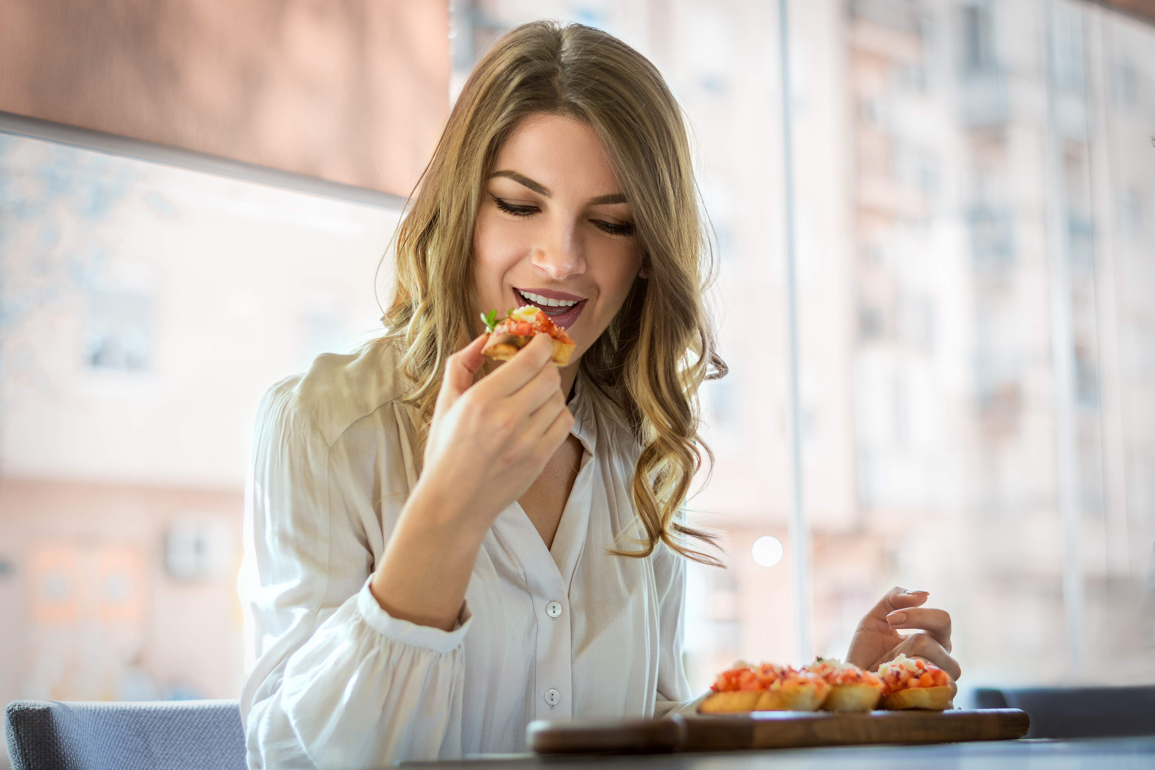 elegant woman eating in cafe