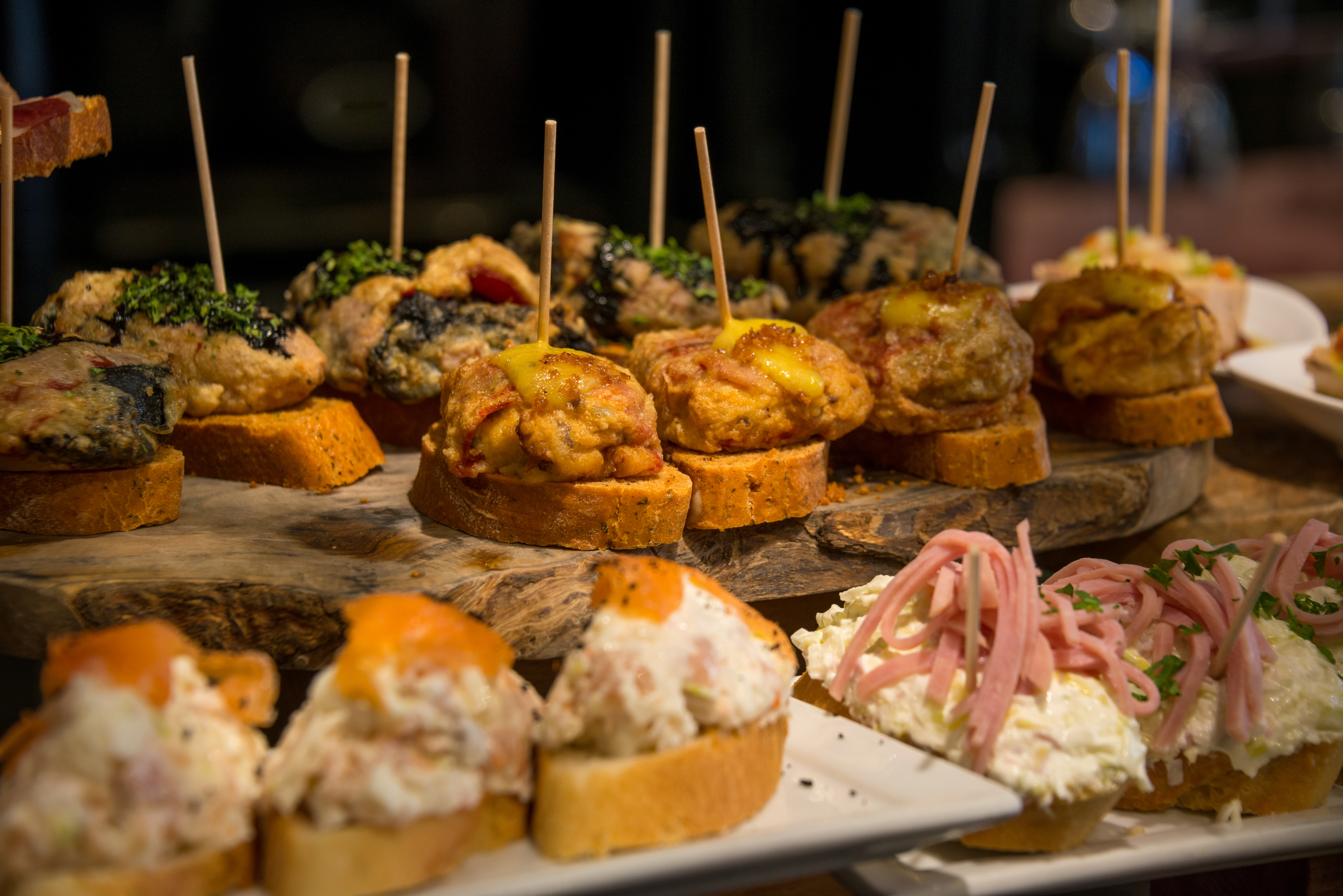 Image with selective focus of various tapas and pinchos in the display of a bar-restaurant in Bilbao, Vizcaya, Basque Country, Spain
