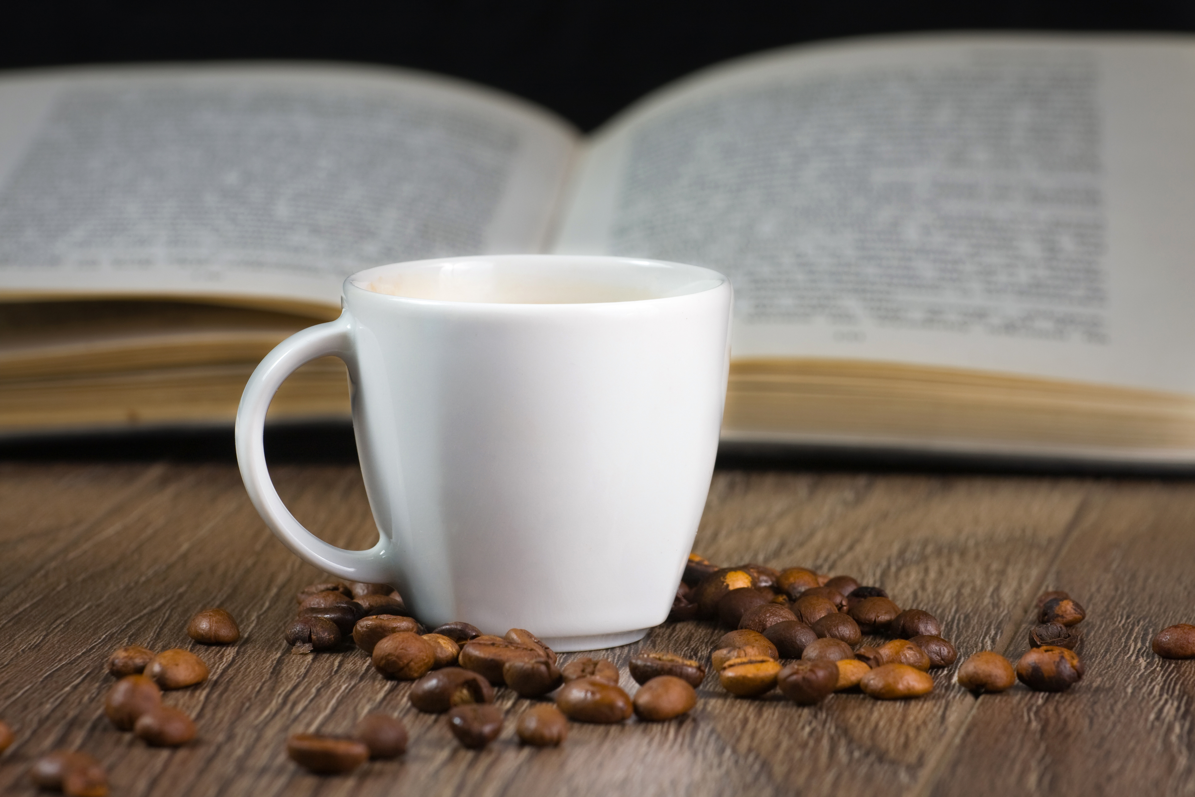 black strong coffee on the table and reading book