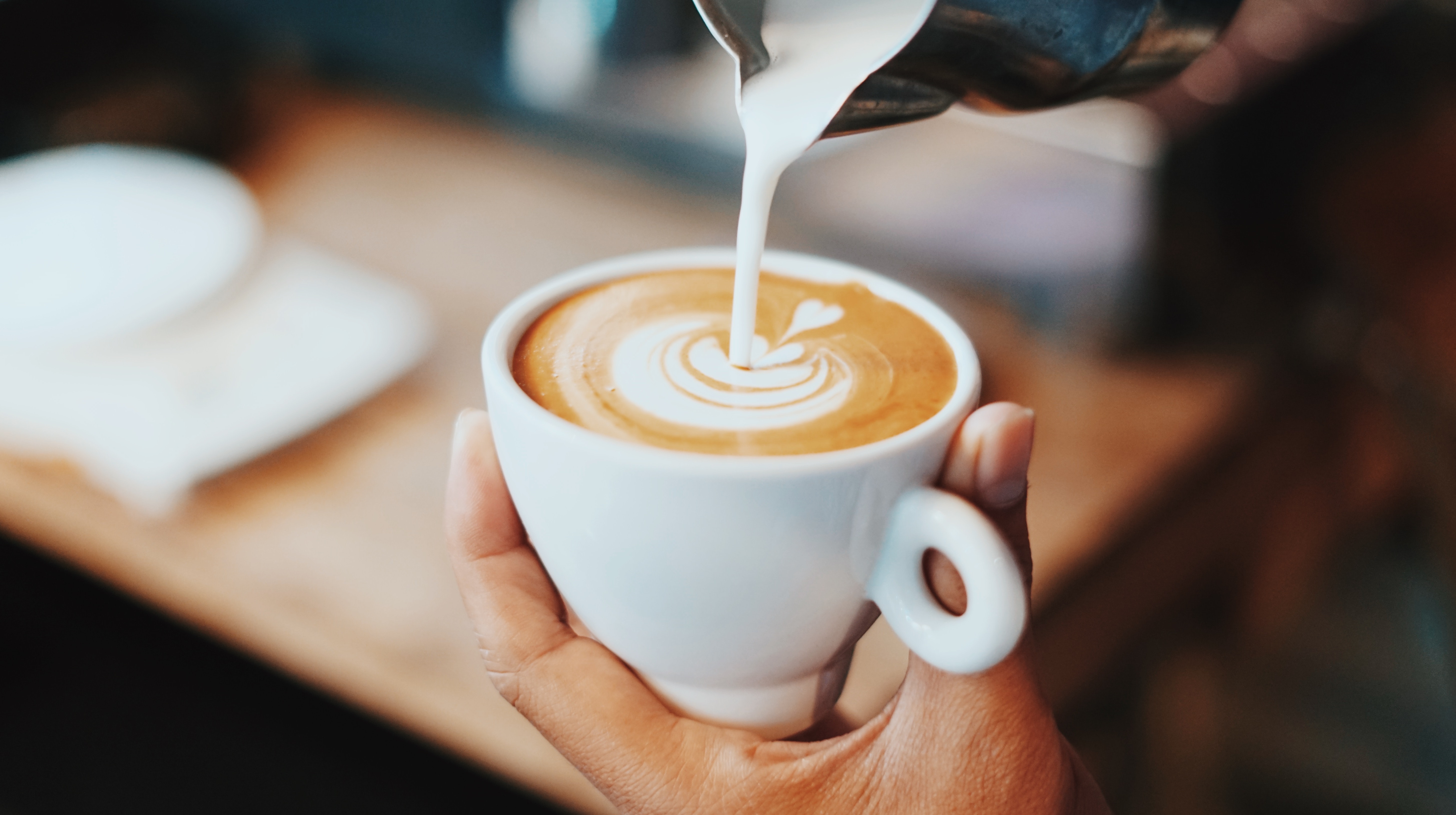 Barista preparing a cup of coffee at a cafe in Paris, France