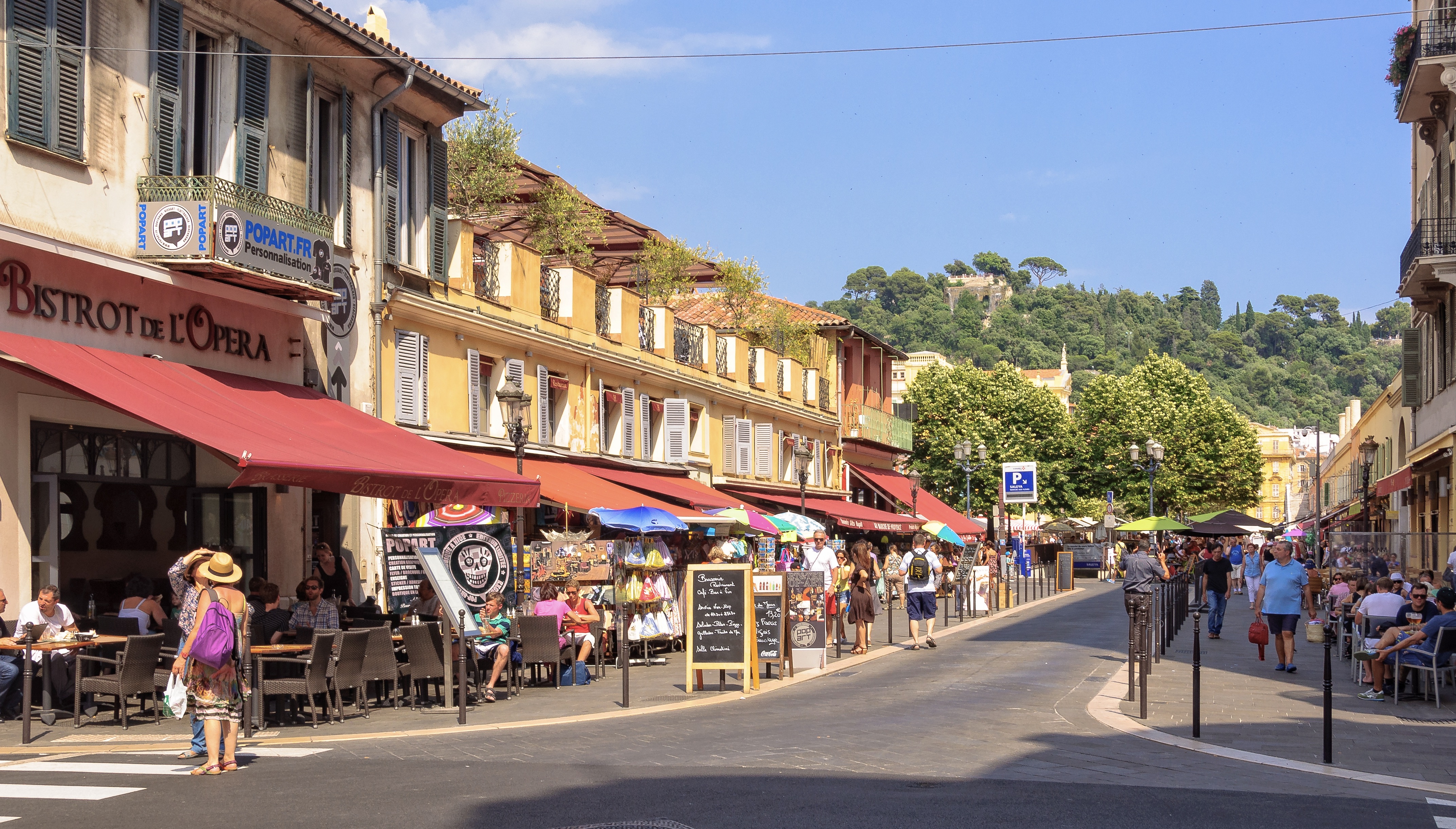 Tourists and locals enjoy a nice meal and drink at the intersection of the Saint-François de Paule and Raoul Bosio streets