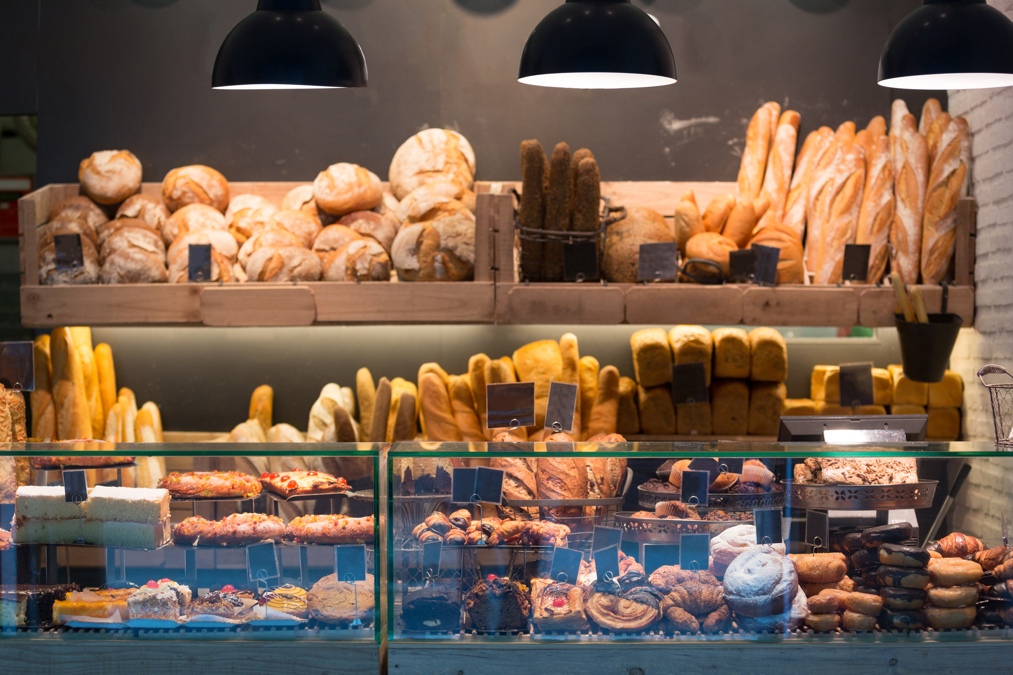 Modern bakery with different kinds of bread, cakes and buns