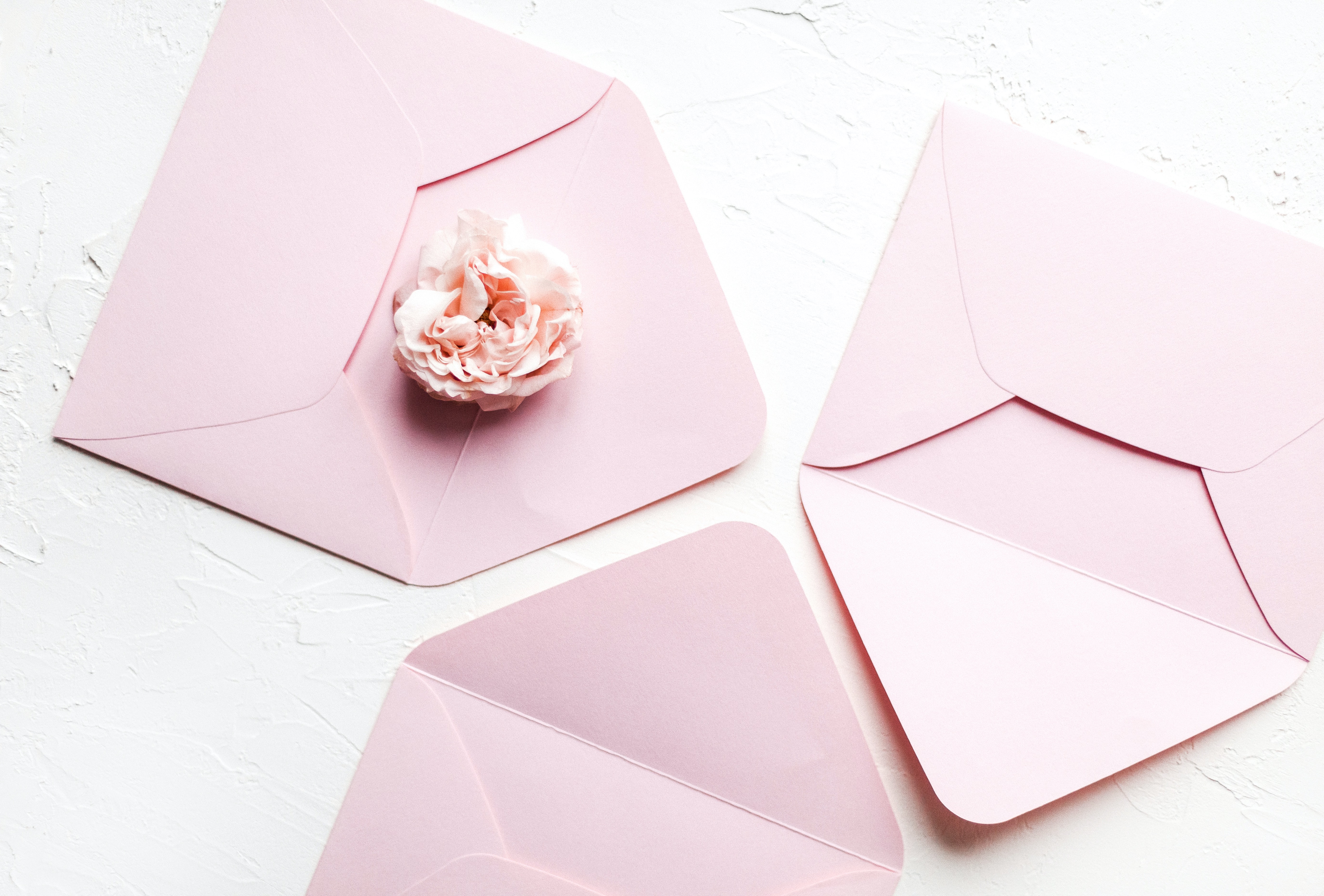 pink envelopes and a flower