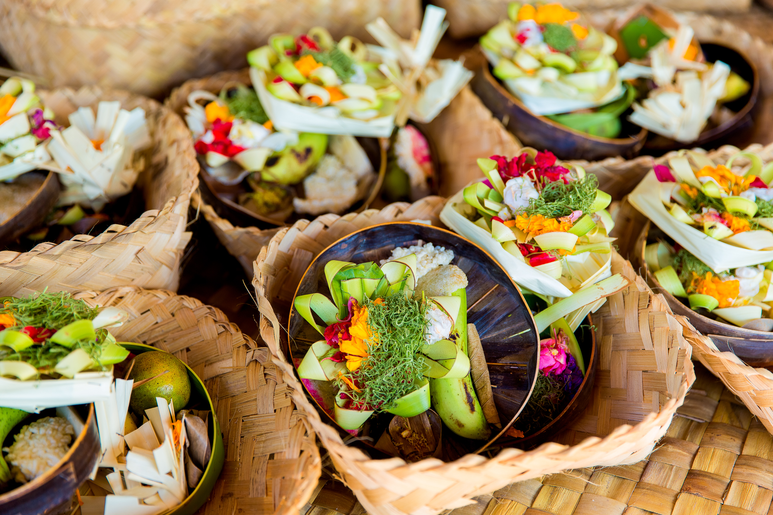 Traditional balinese offerings to gods in Bali with flowers and aromatic sticks