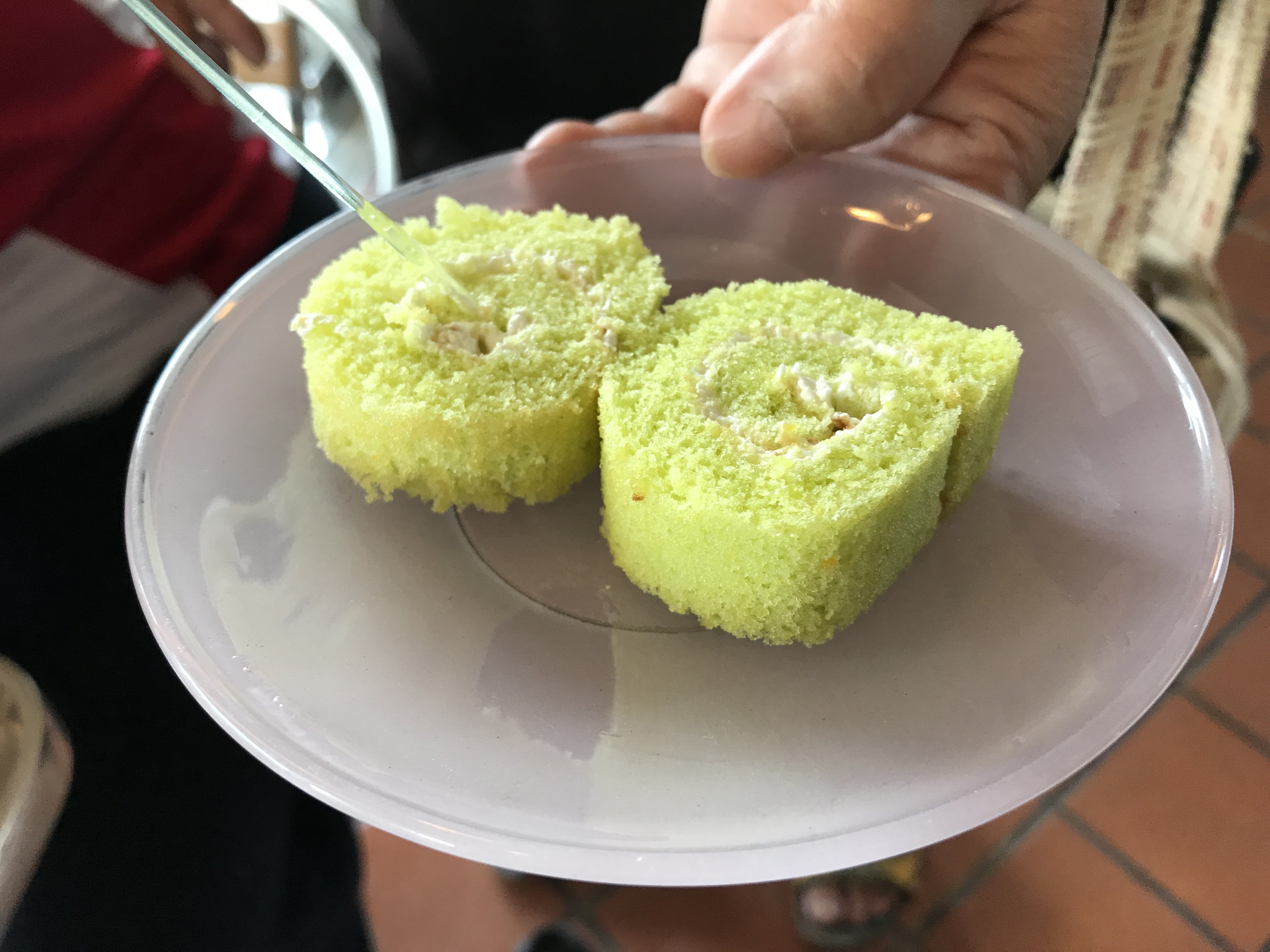 Two pieces of pandanus flavor roll cake, yam roll, jam roll