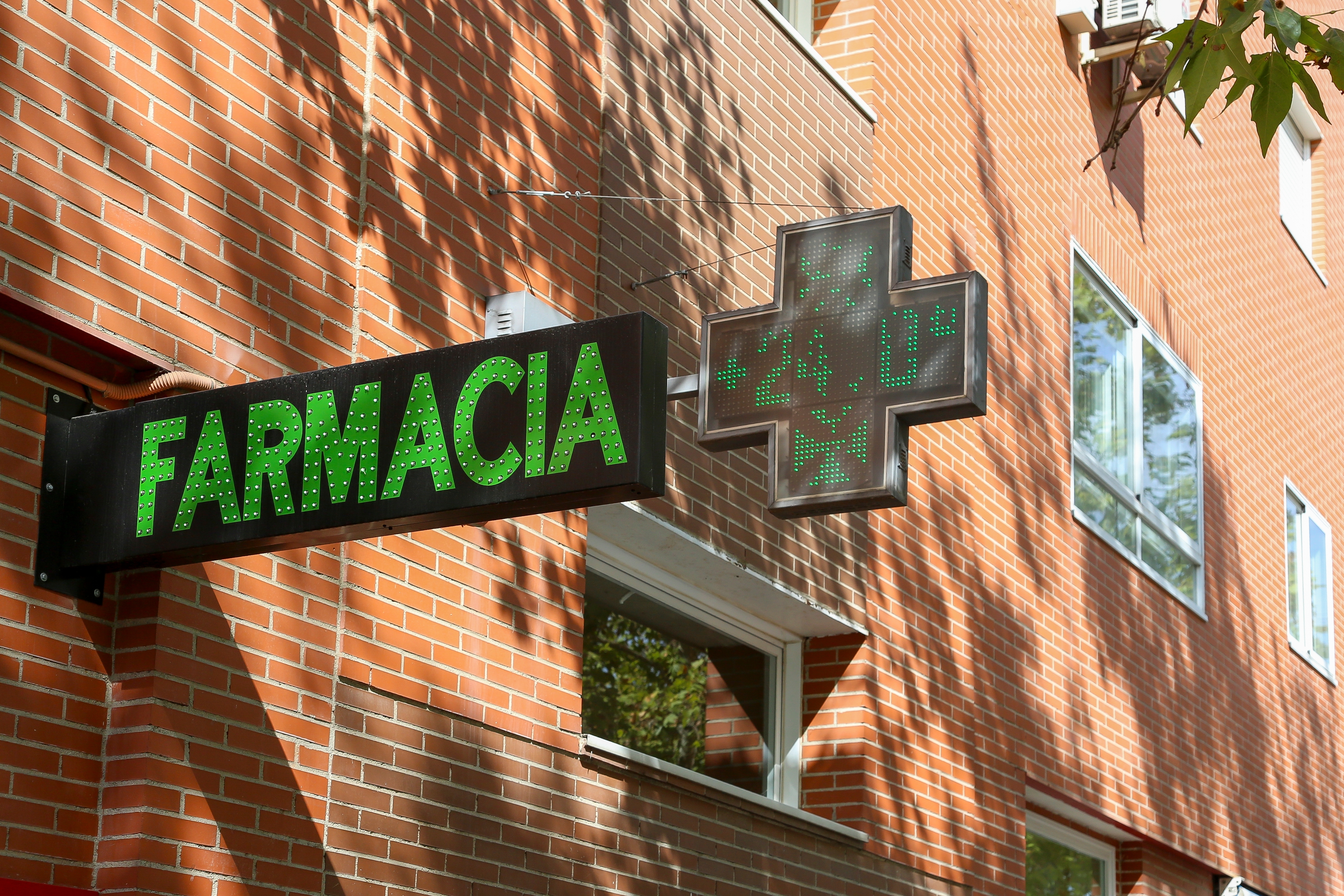 Pharmacy sign at a store selling medical products and drugs in the capital of Spain.